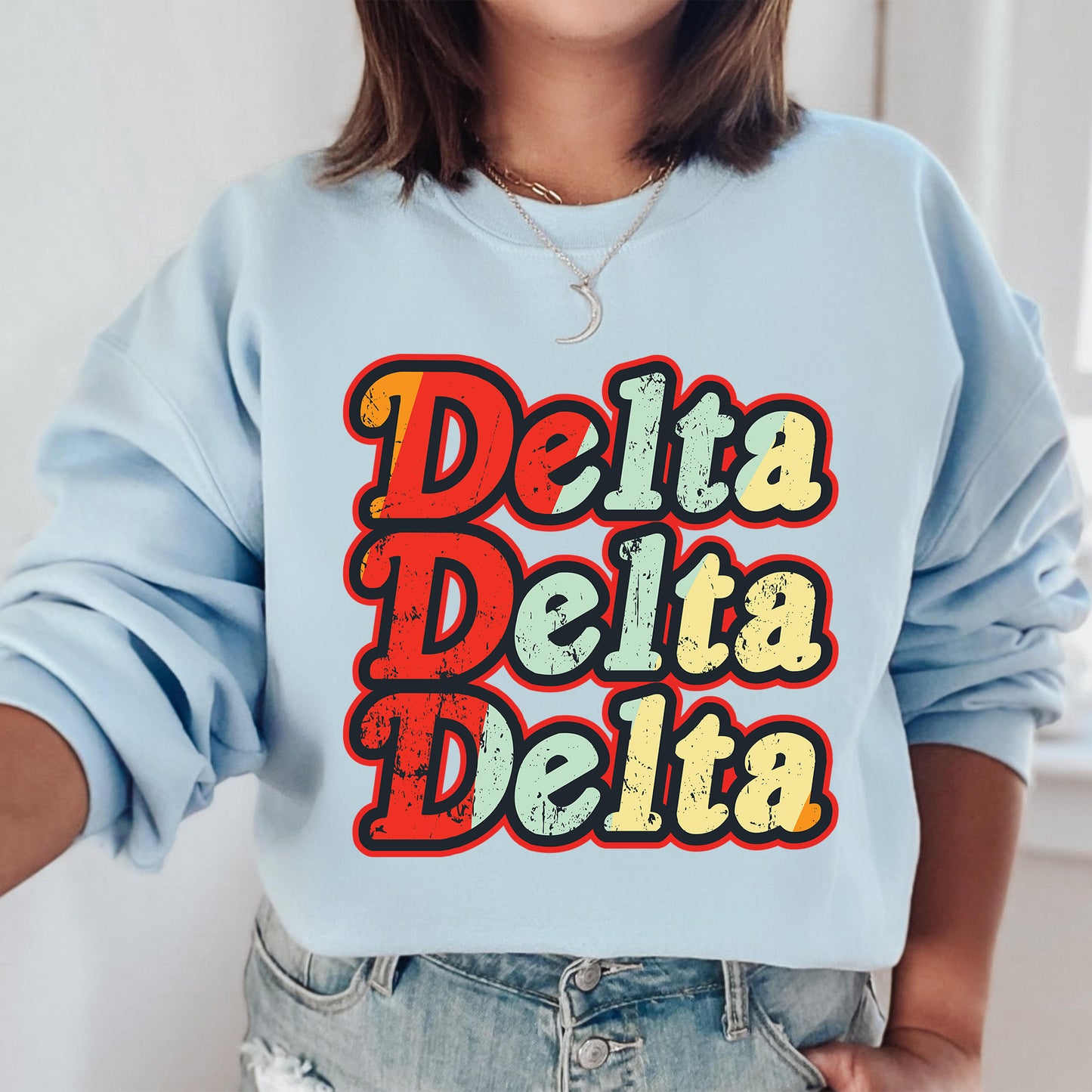a woman wearing a sweatshirt that says delta delta