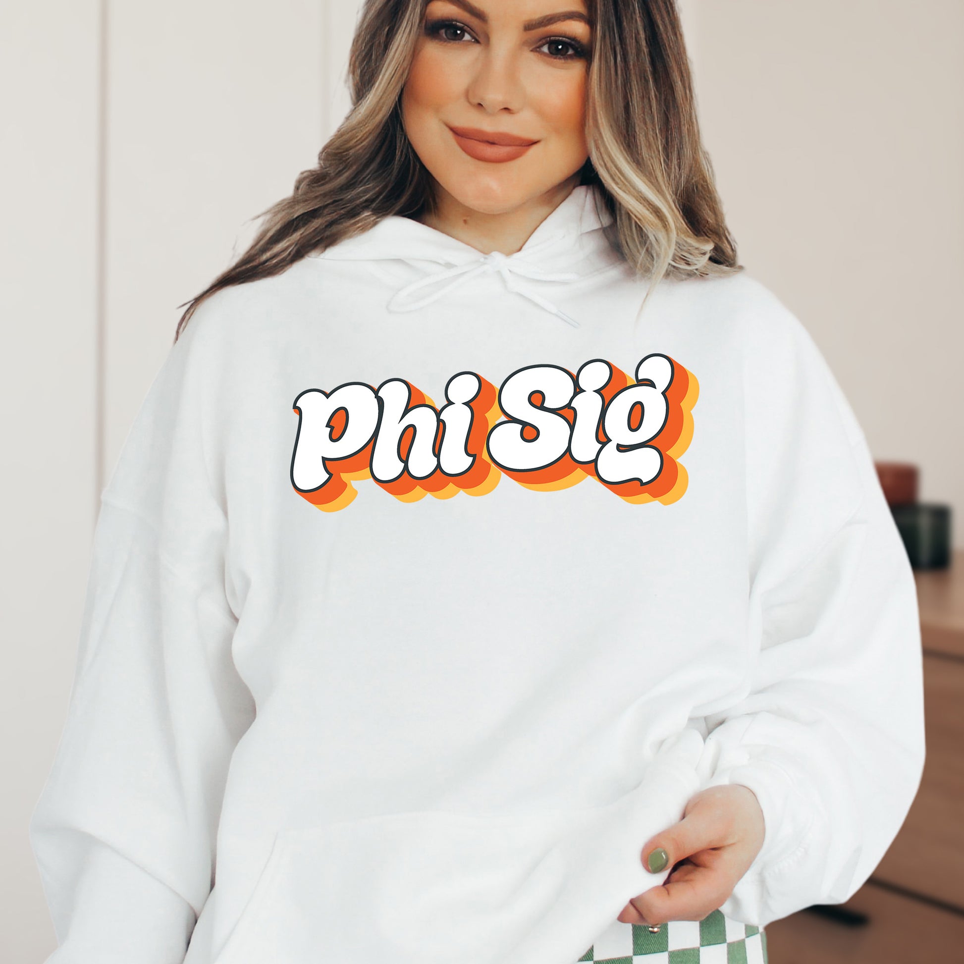 a woman wearing a white phi sig hoodie