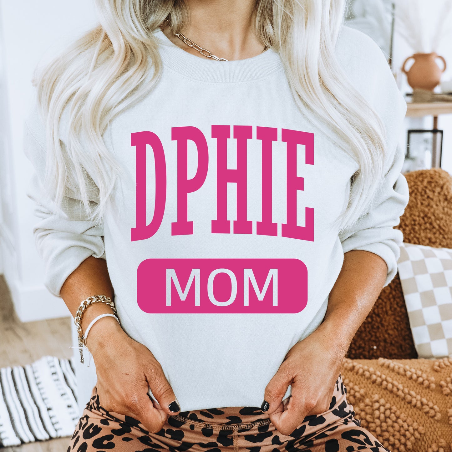 a woman wearing a sweatshirt that says dppie mom