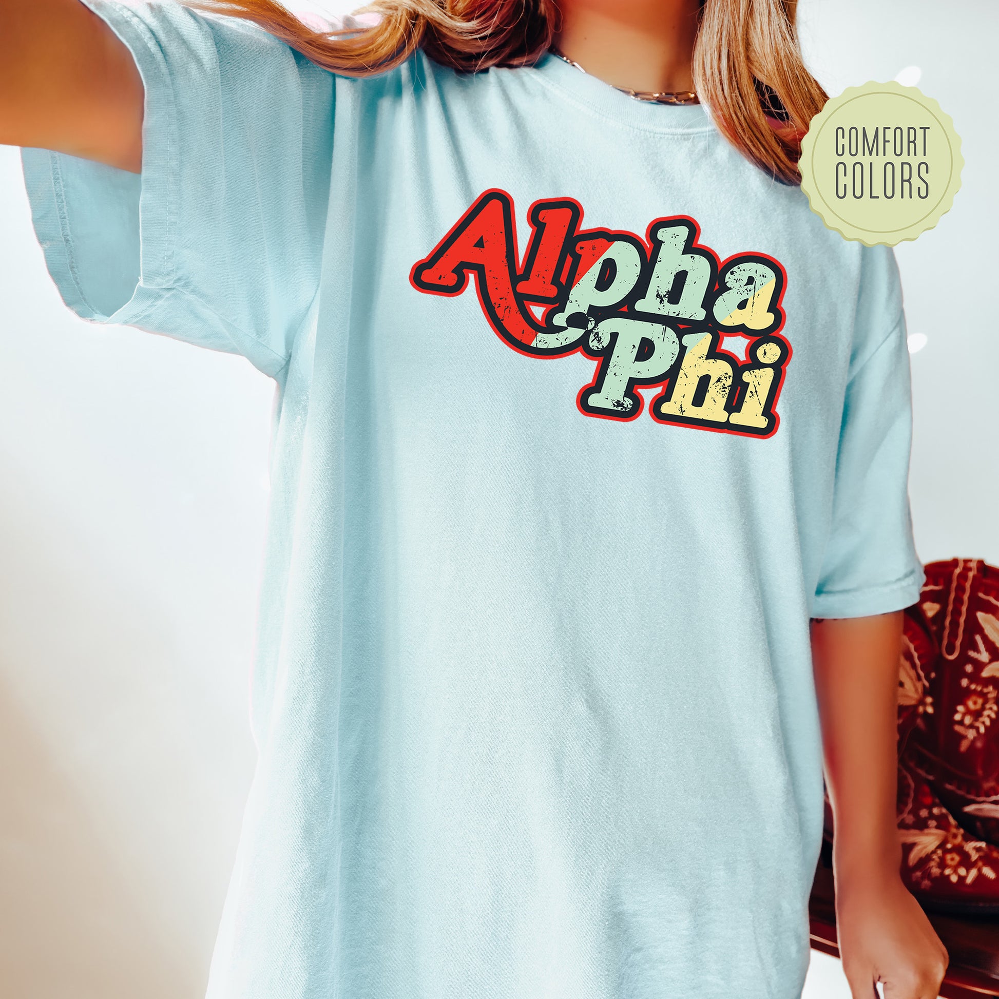 a woman wearing a light blue shirt with the alphabet phi on it