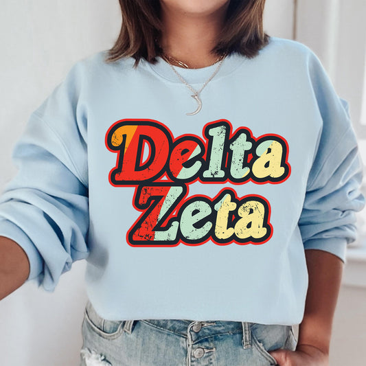 a woman wearing a sweatshirt that says delta zeia