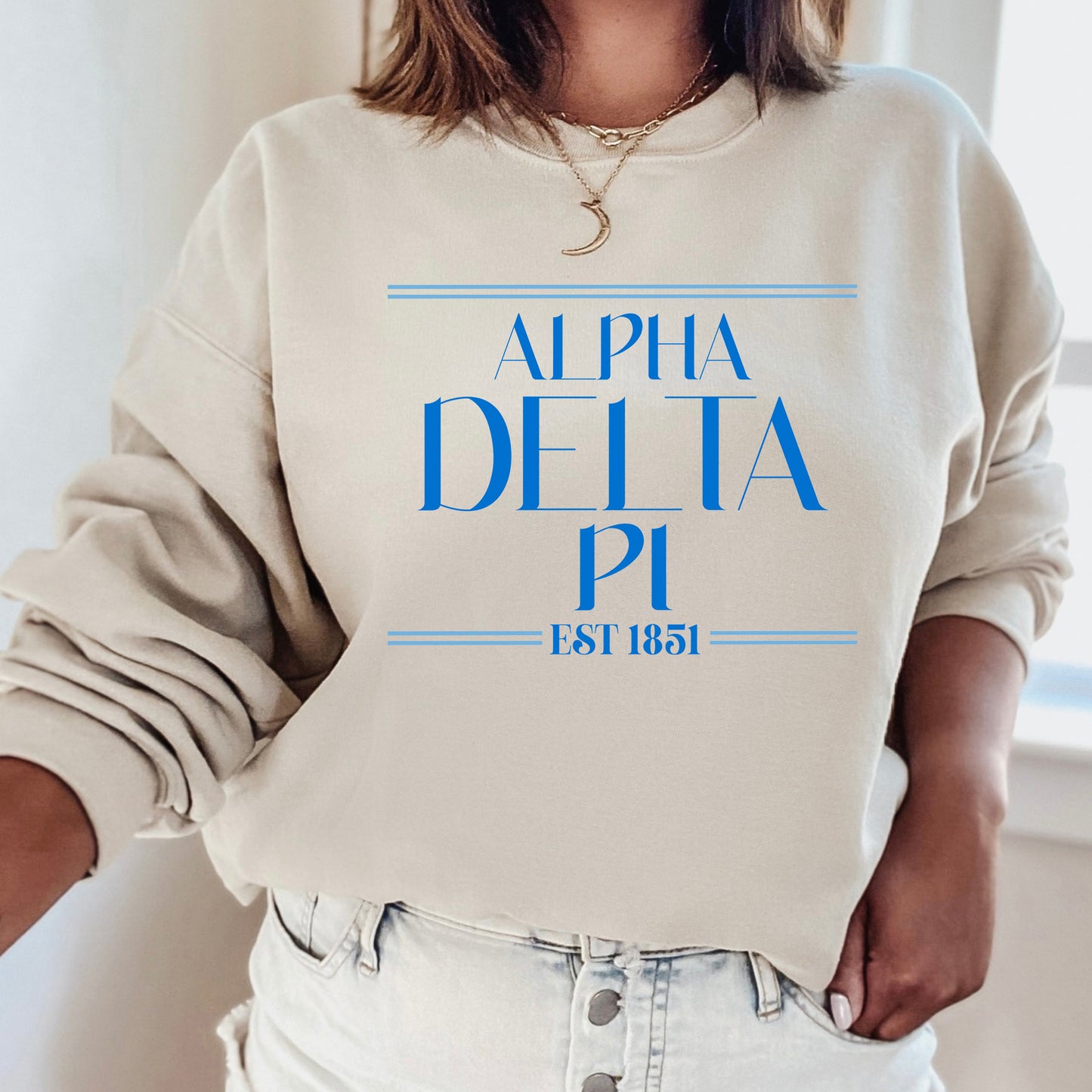 a woman wearing a sweatshirt with the word delta pi printed on it