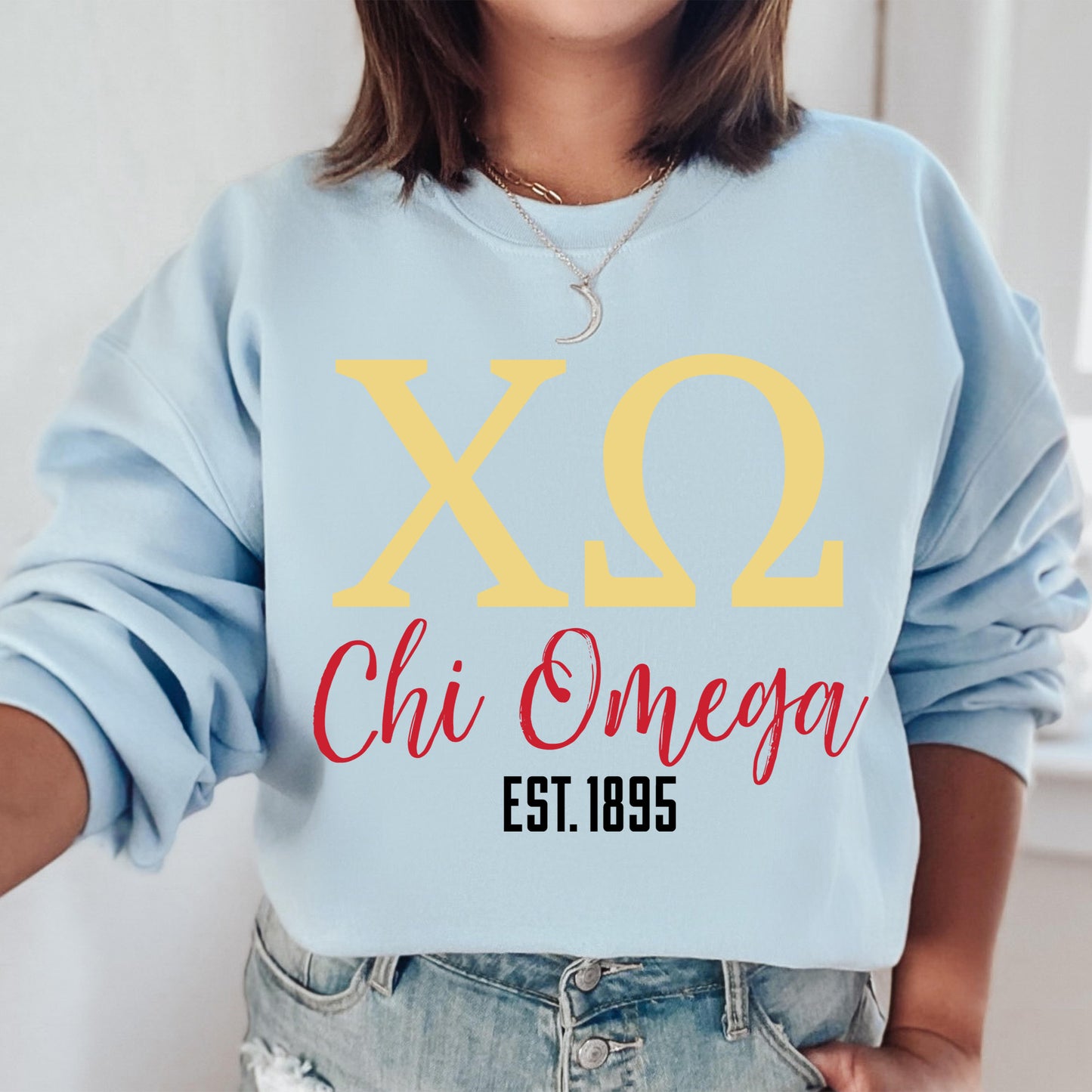 a woman wearing a sweatshirt that says x2 chi onega est 1989