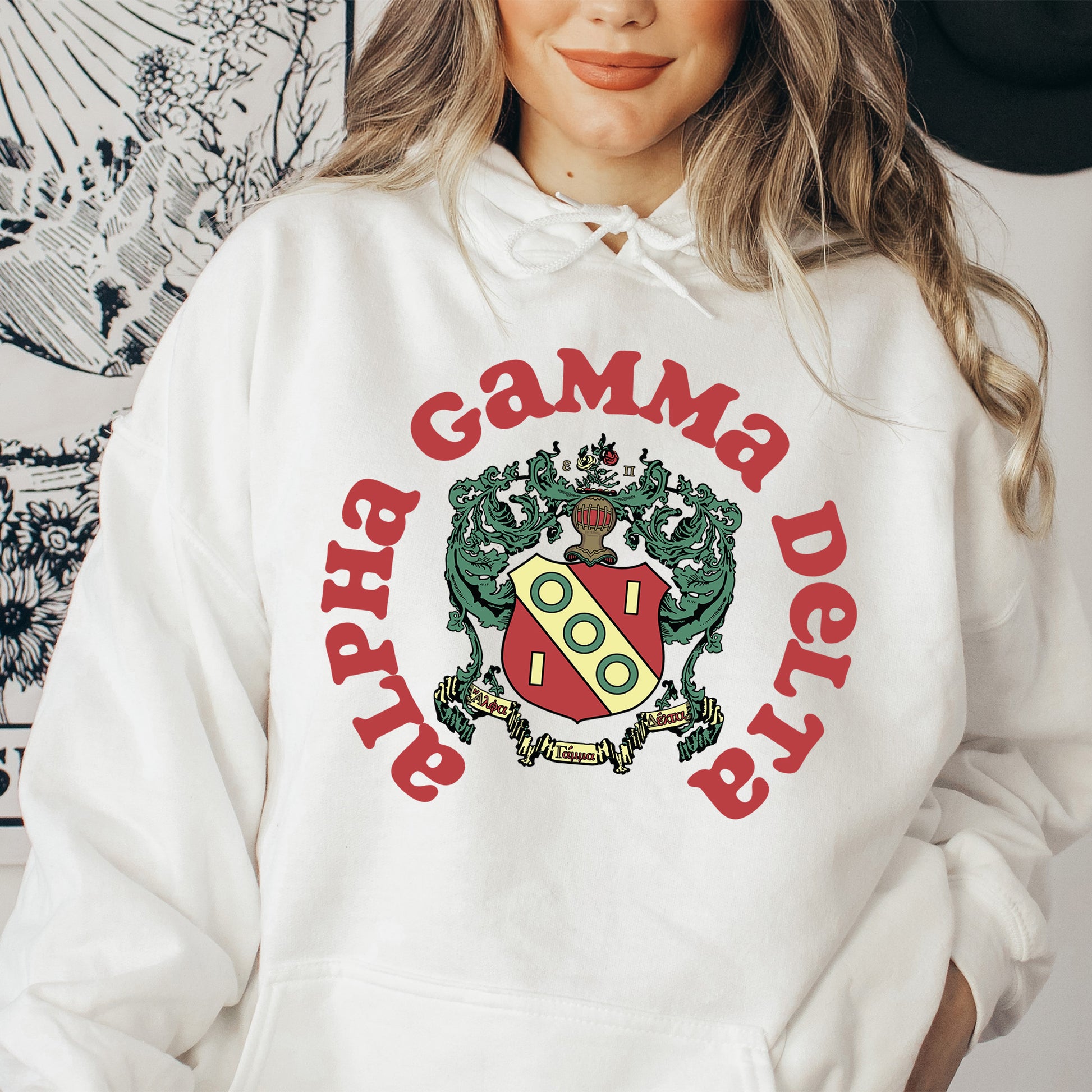 a woman wearing a white hoodie with a crest on it