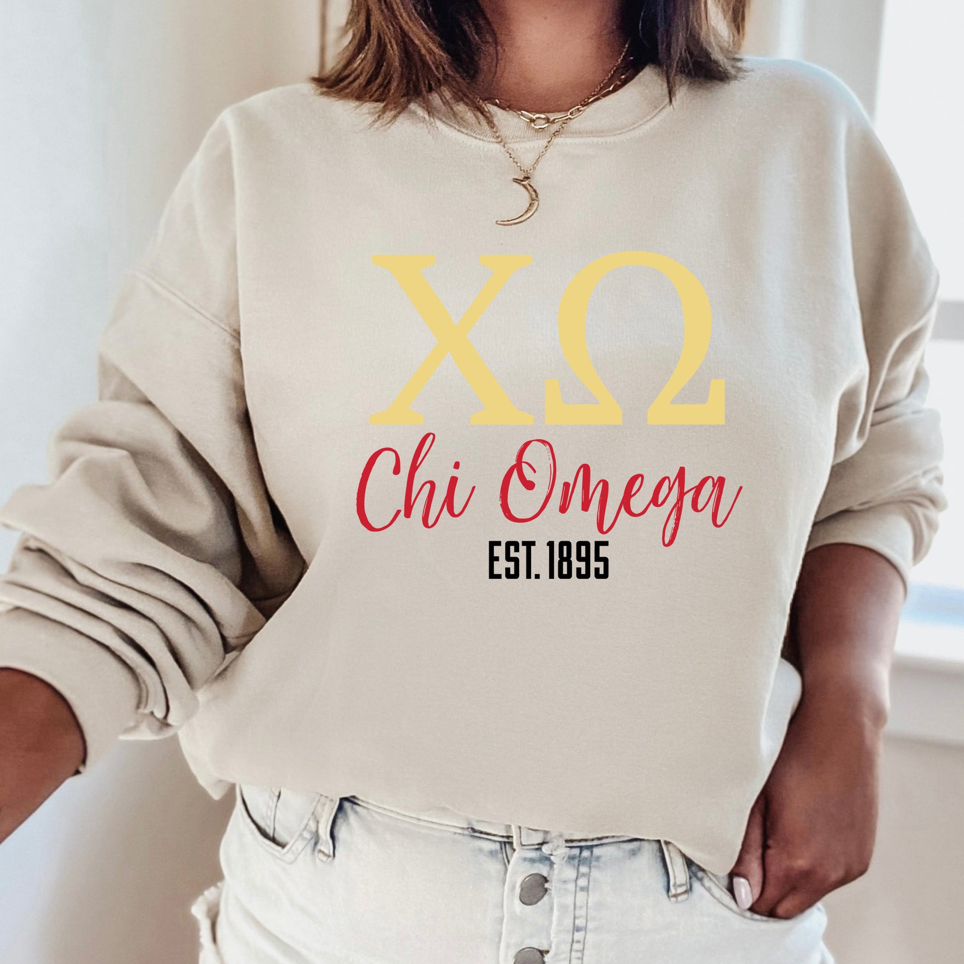 a woman wearing a sweatshirt that says x2 chi omega