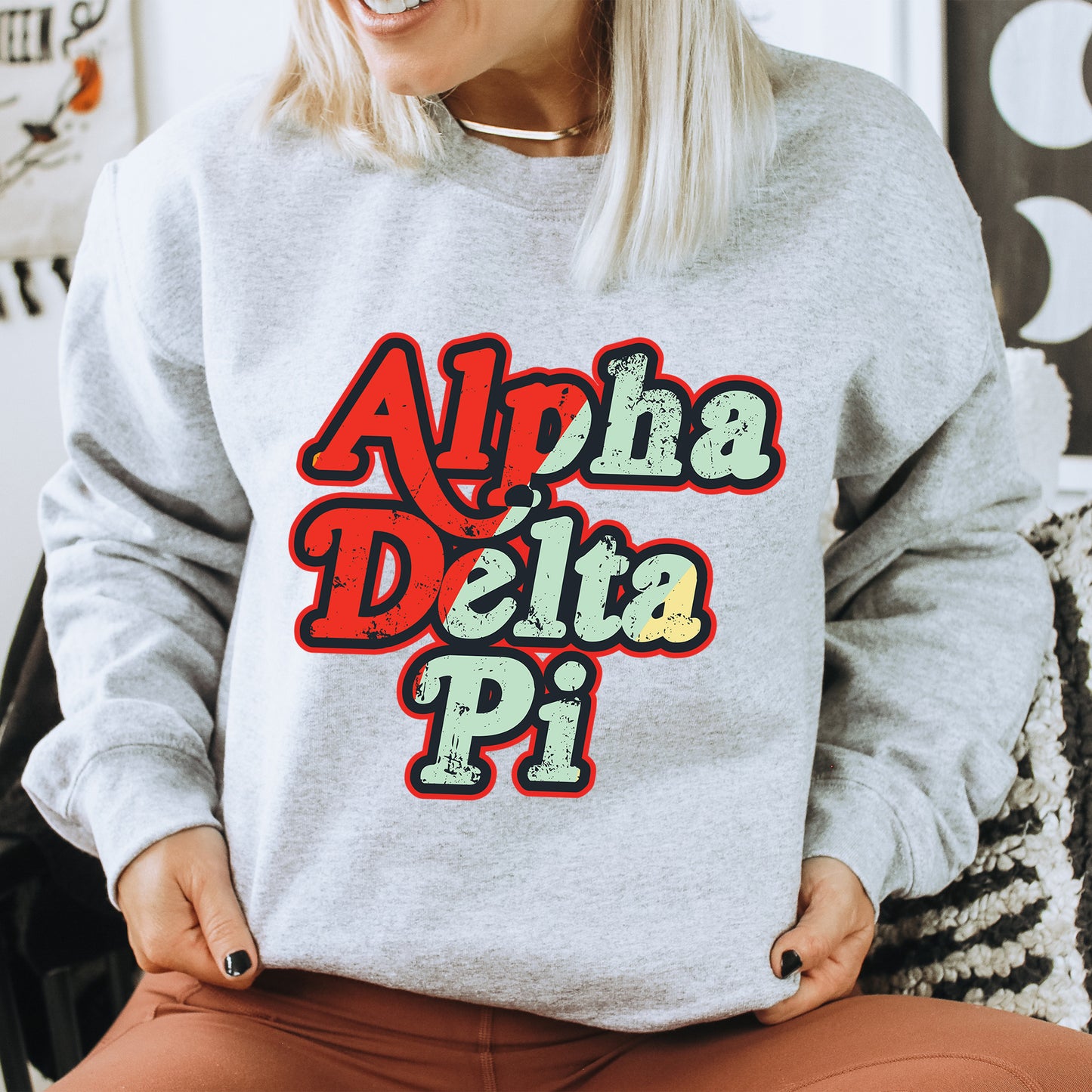 a woman wearing a sweatshirt that says aloh delta pi