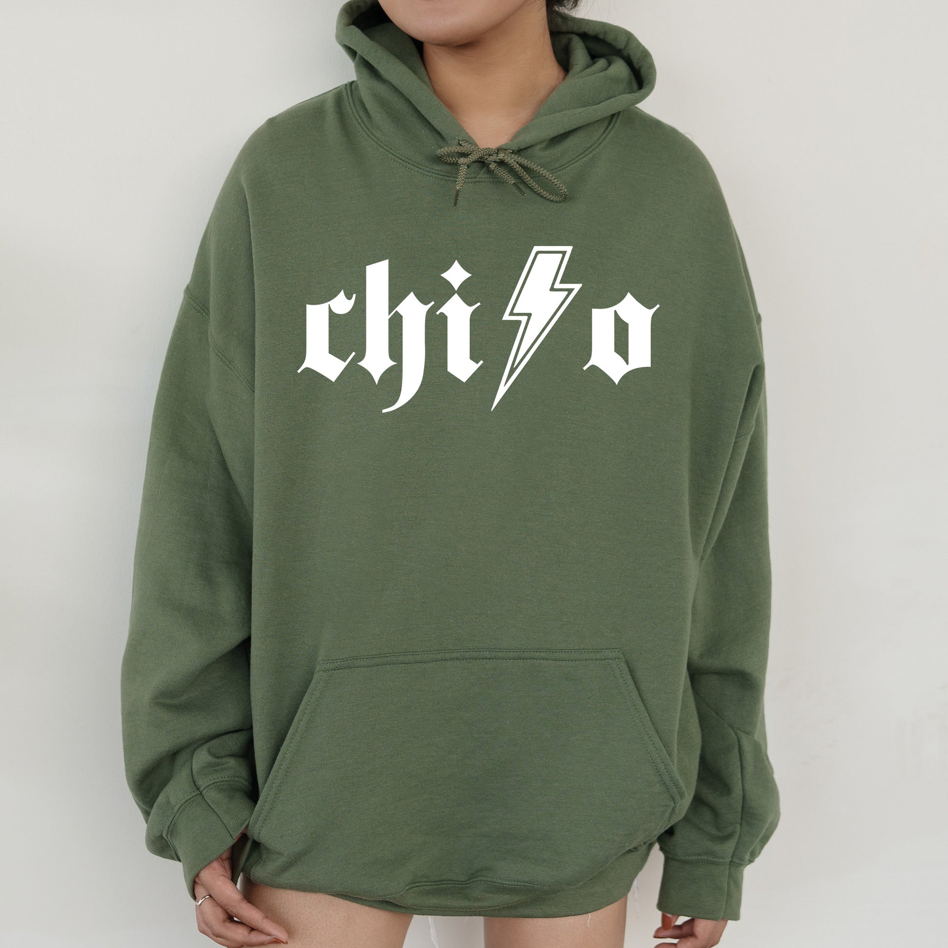 a person wearing a green hoodie with a lightning bolt on it