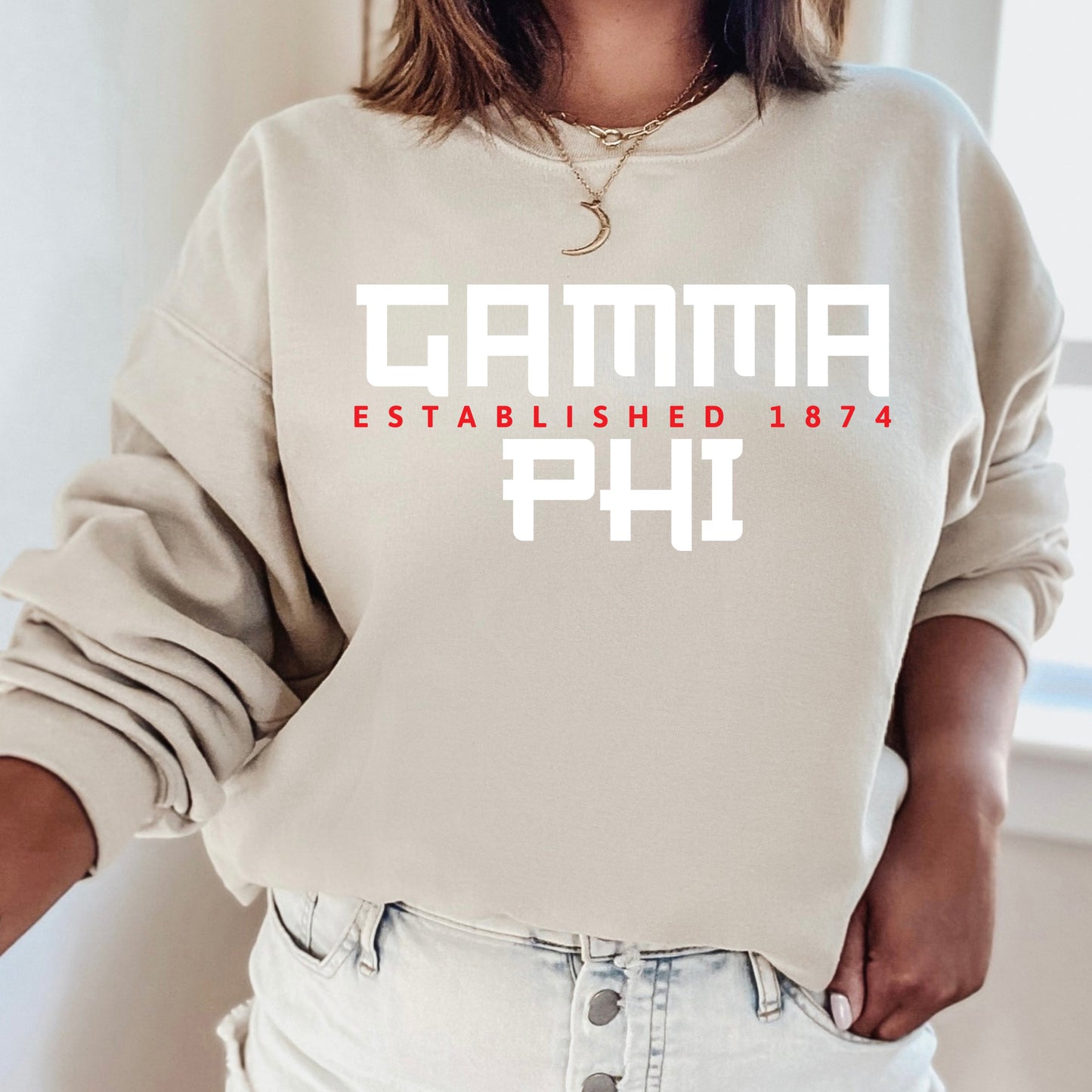 a woman wearing a sweatshirt that says garma established 1974