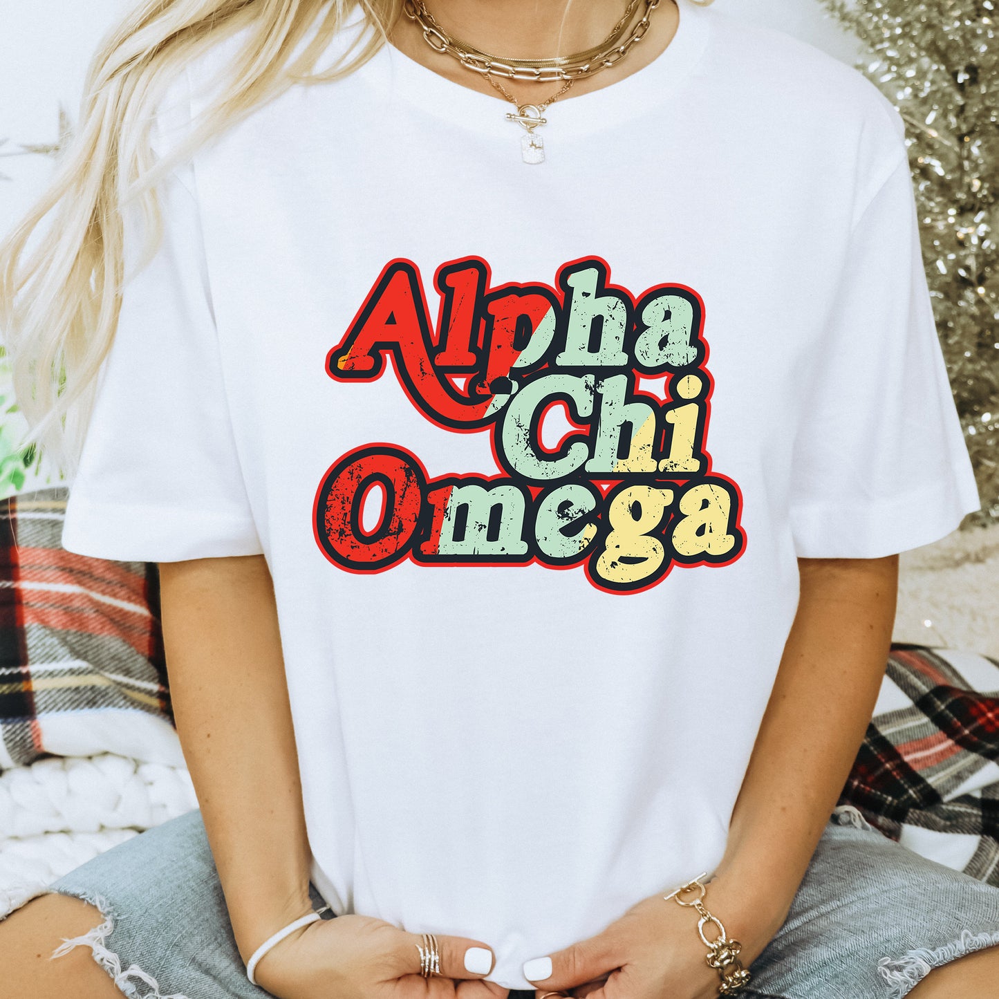 a woman wearing a t - shirt that says alpha chi omega