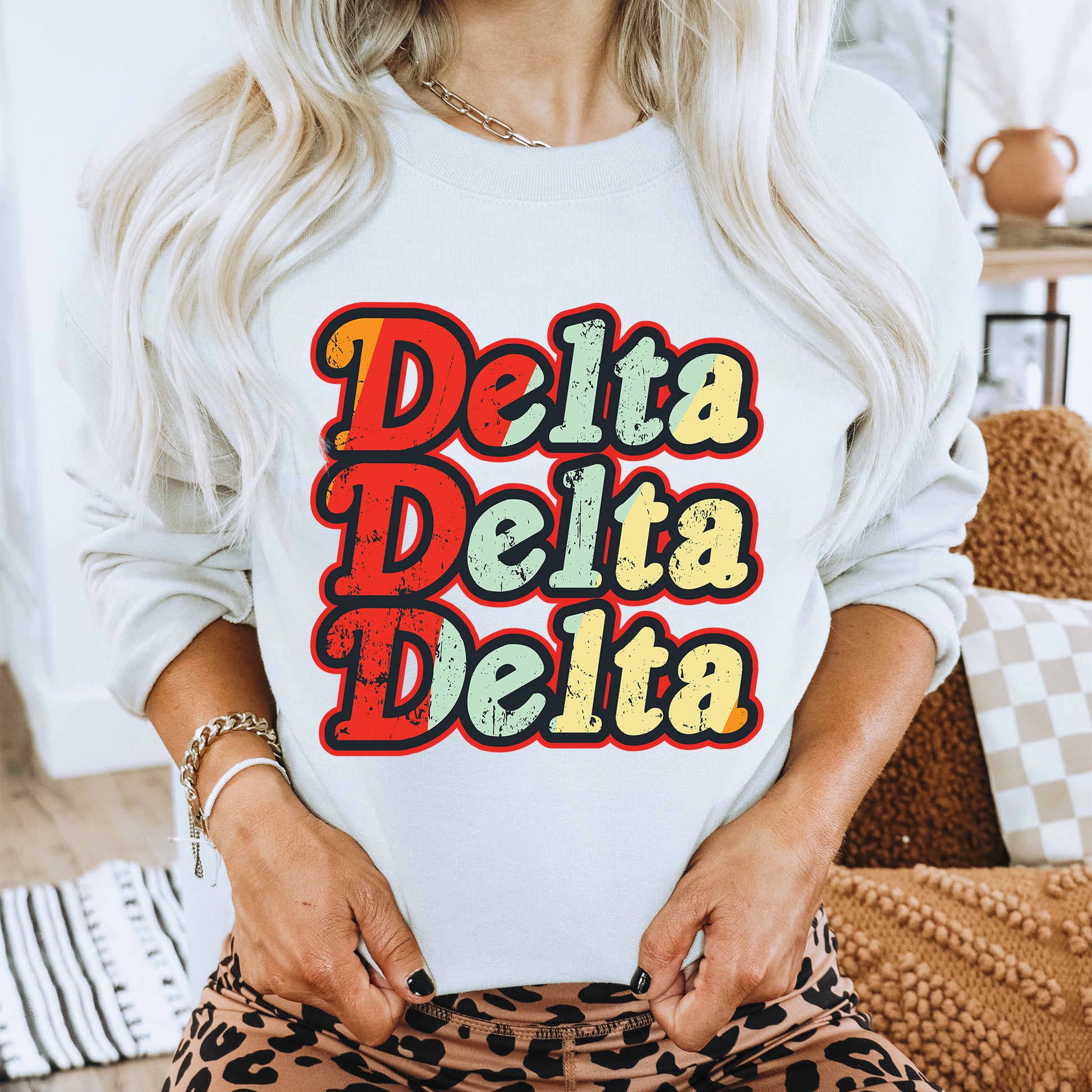 a woman wearing a sweatshirt that says delta delta