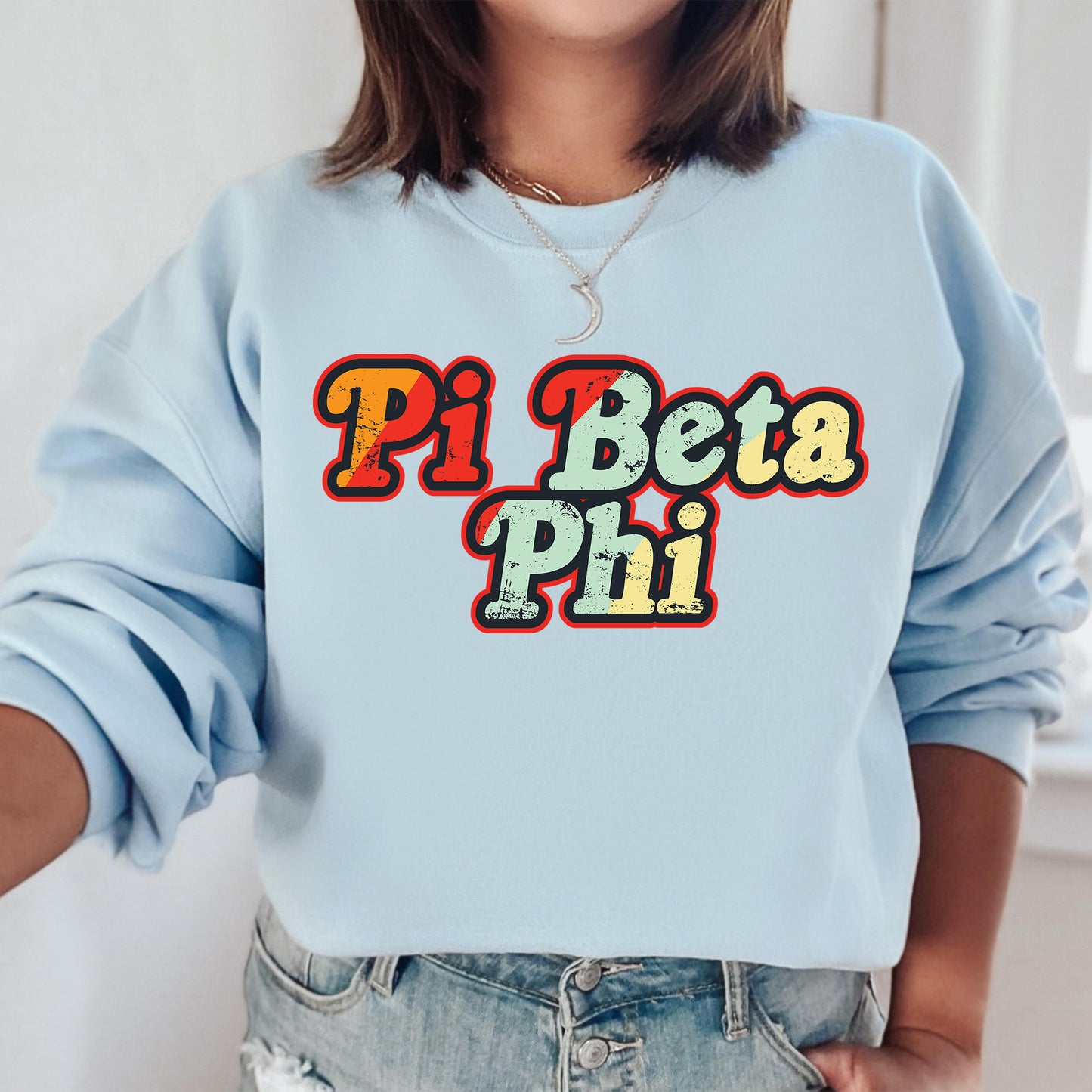 a woman wearing a blue sweatshirt that says pi beta phi