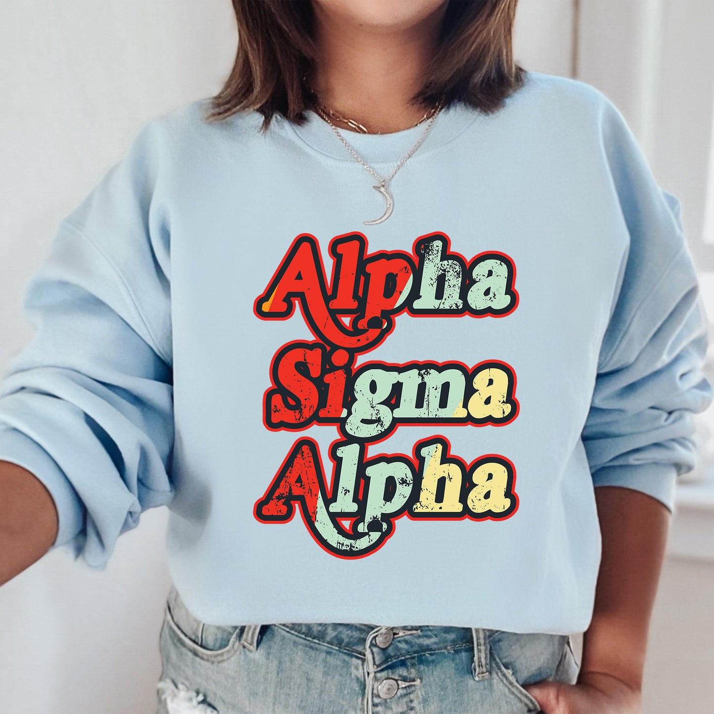 a woman wearing a light blue sweatshirt with the words aloha and aloh