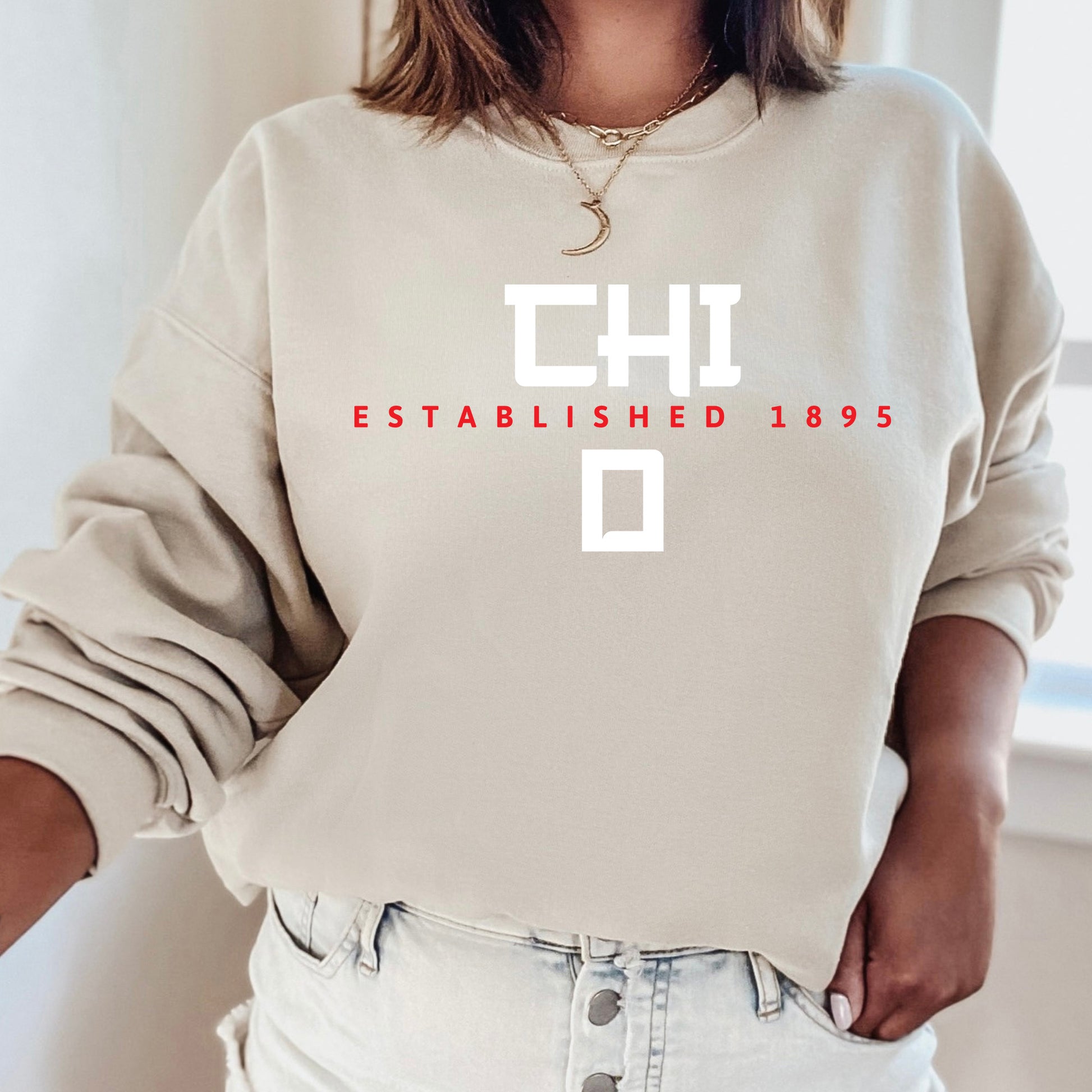 a woman wearing a sweatshirt that says the established 1953