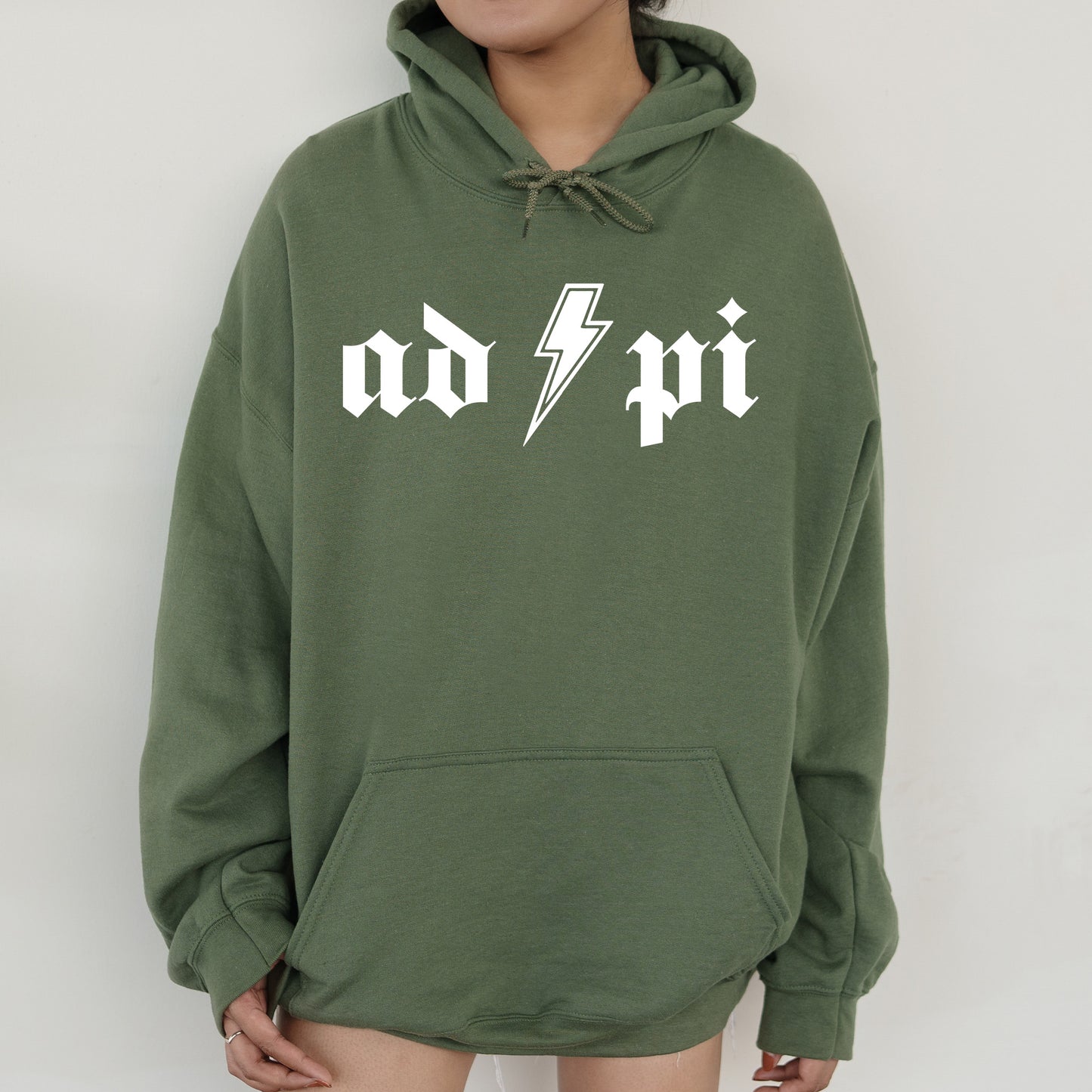 a person wearing a green hoodie with a lightning bolt on it
