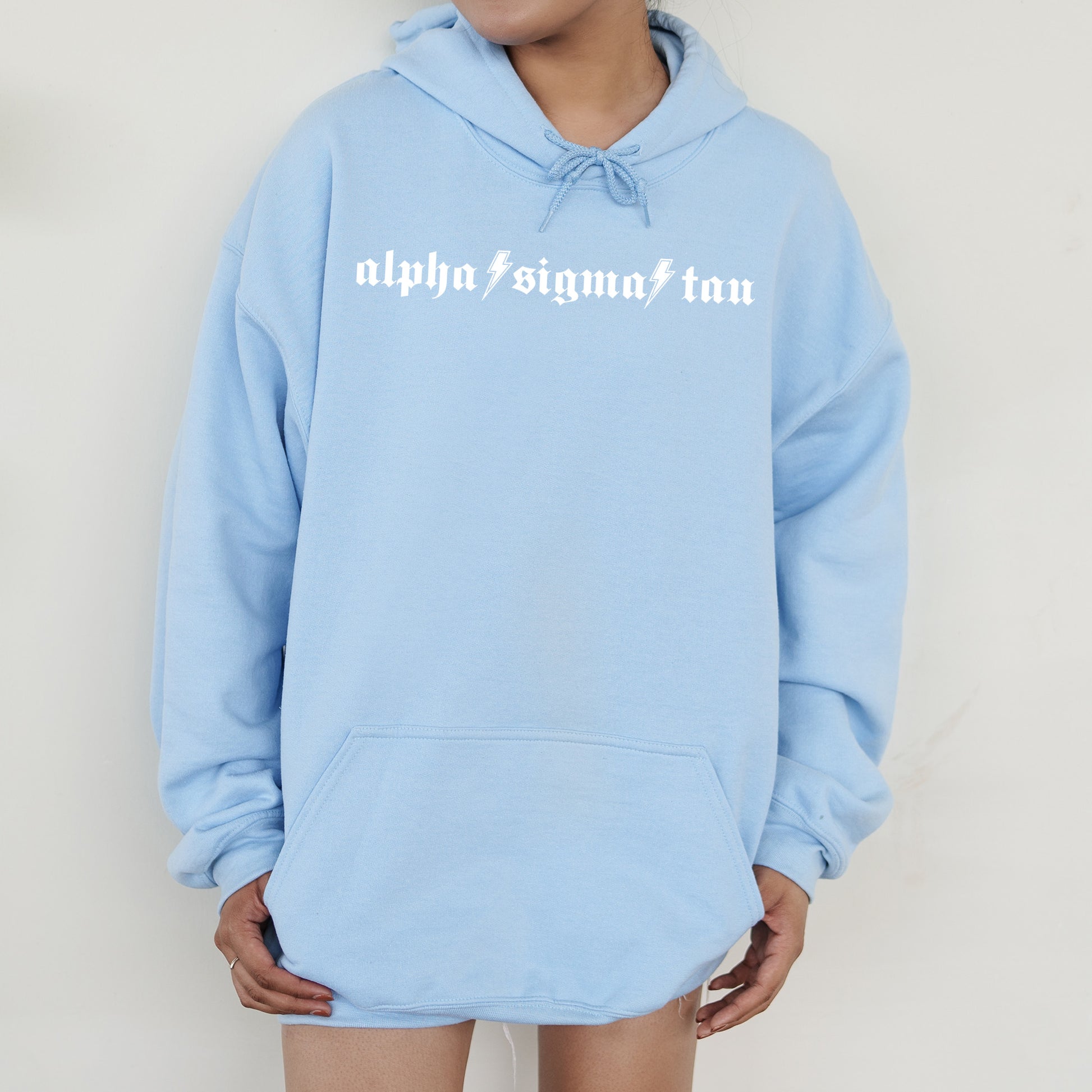 a person wearing a blue hoodie with white writing on it