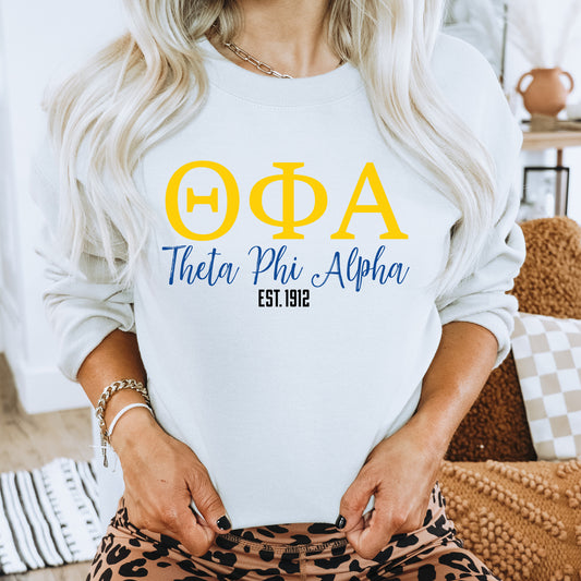 a woman wearing a white sweatshirt with a yellow phi phi symbol on it