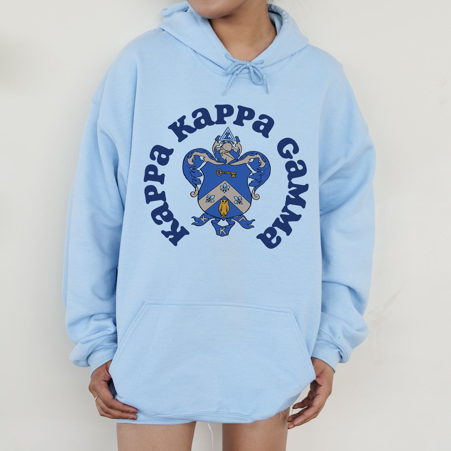 a person wearing a blue hoodie with a heart on it