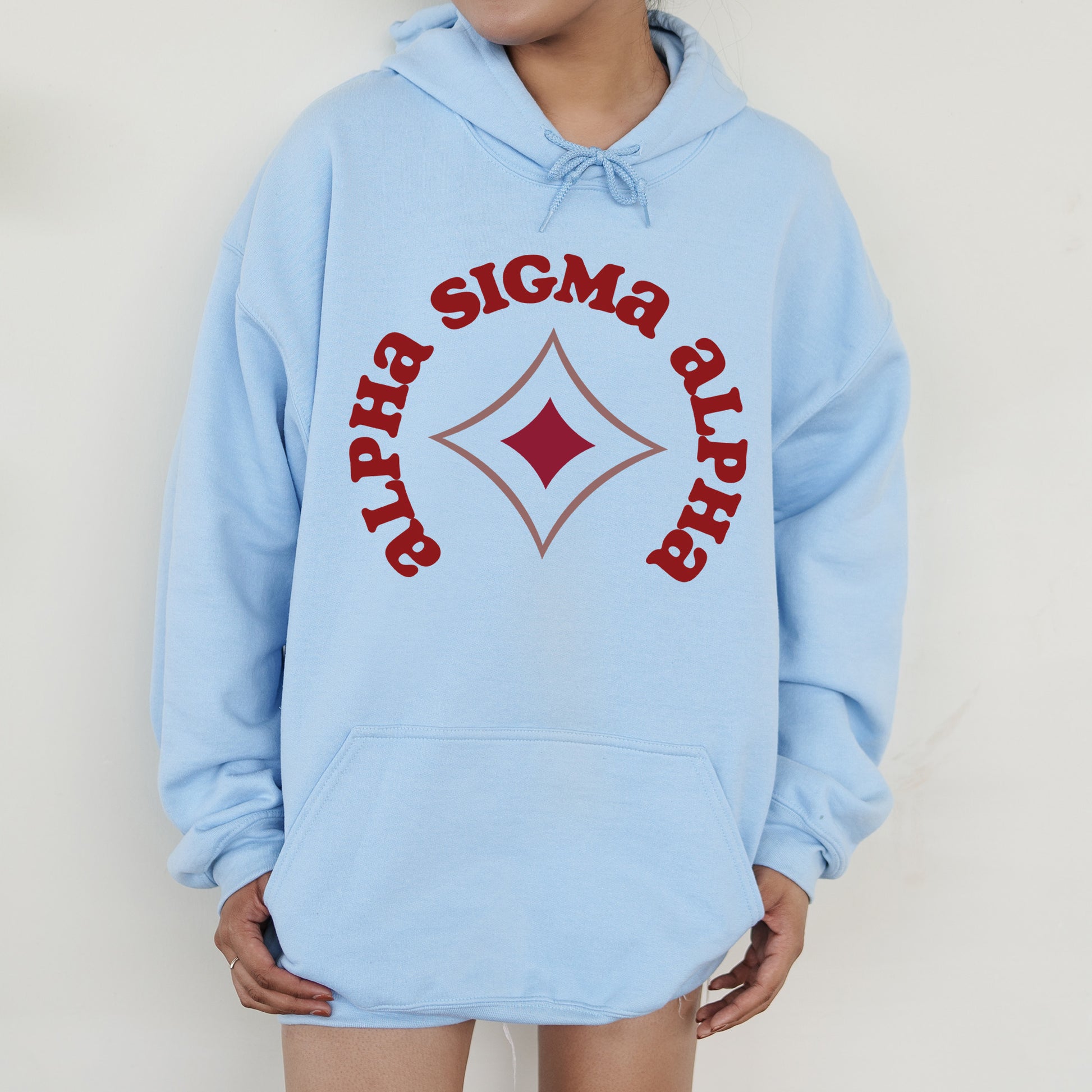 a person wearing a blue sweatshirt with a red logo on it