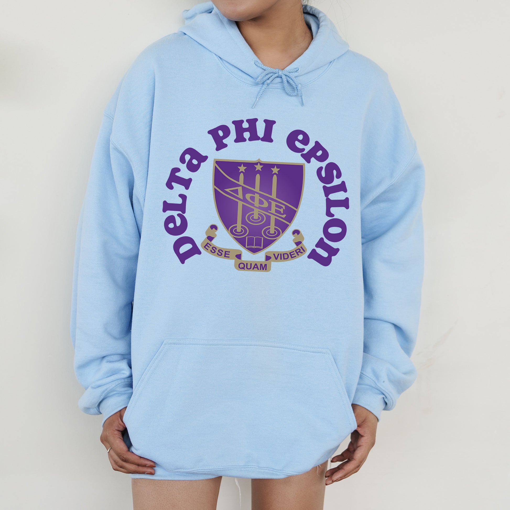a person wearing a blue hoodie with a purple logo