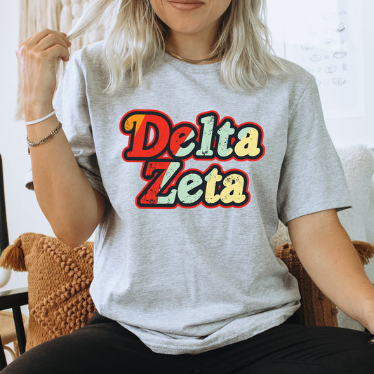 a woman sitting on a chair wearing a delta delta t - shirt