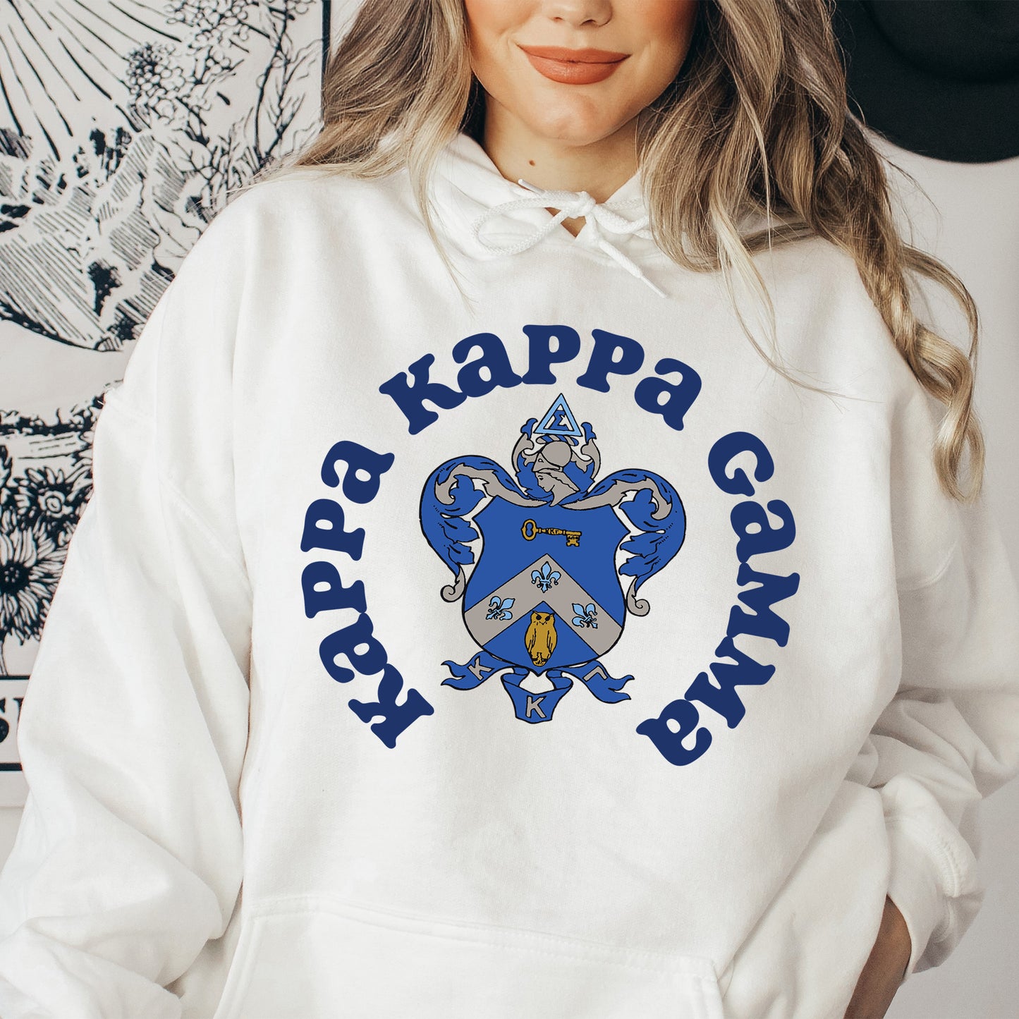 a woman wearing a happy kappa gang hoodie