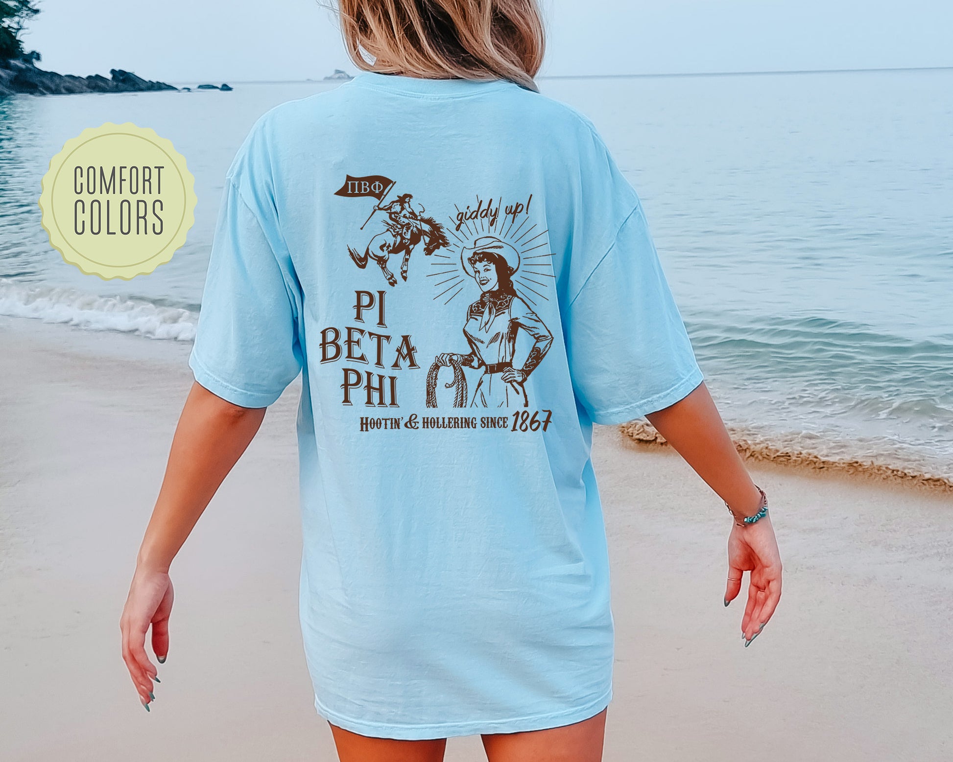 a woman walking on a beach next to the ocean