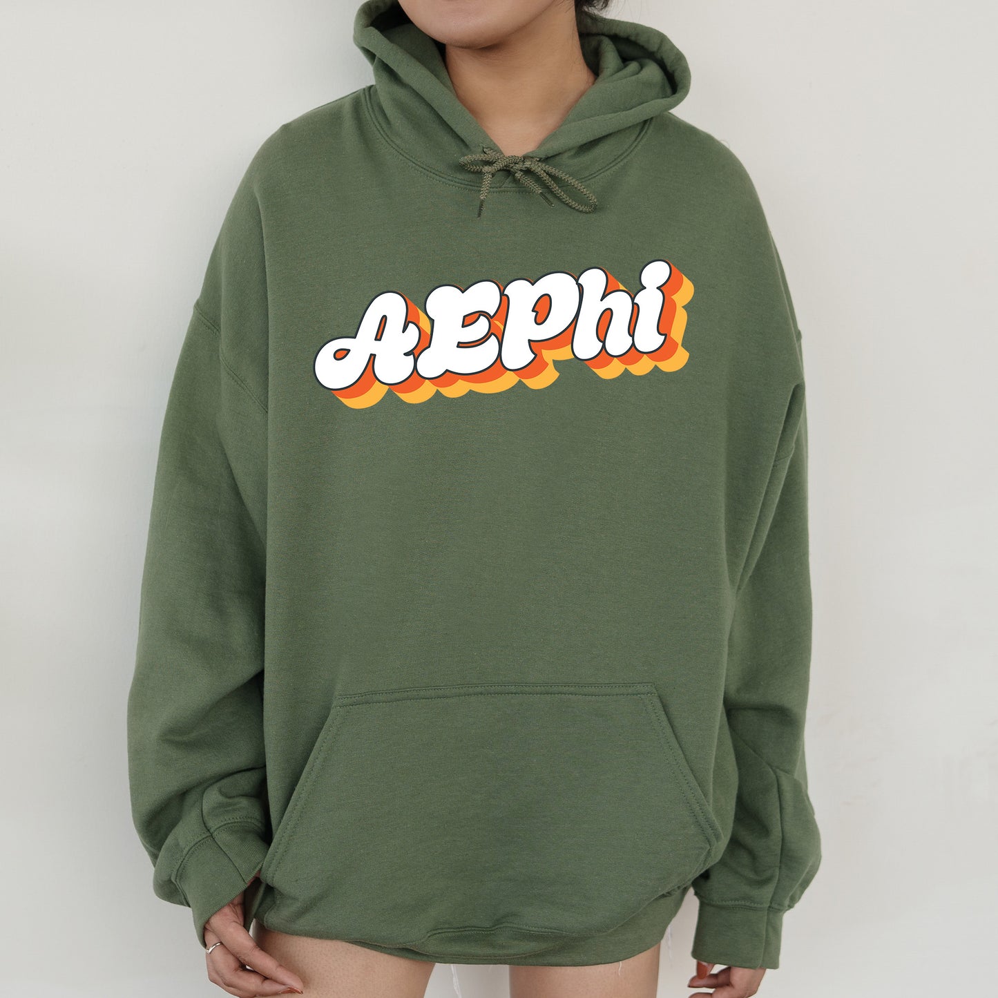 a person wearing a green hoodie with the word peppi printed on it