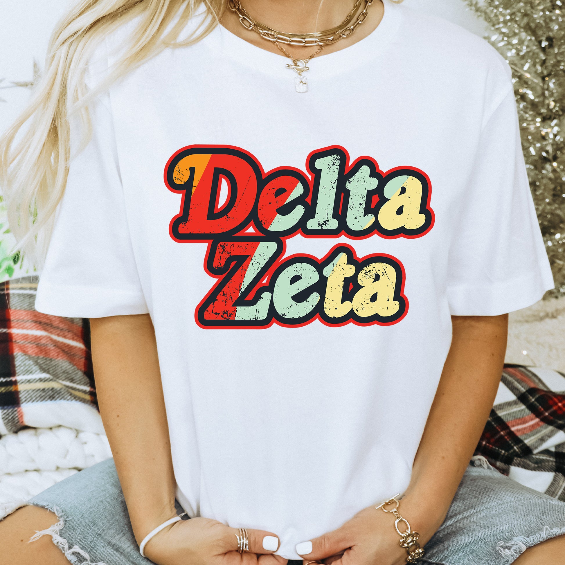 a woman wearing a white shirt with the word delta zeta on it