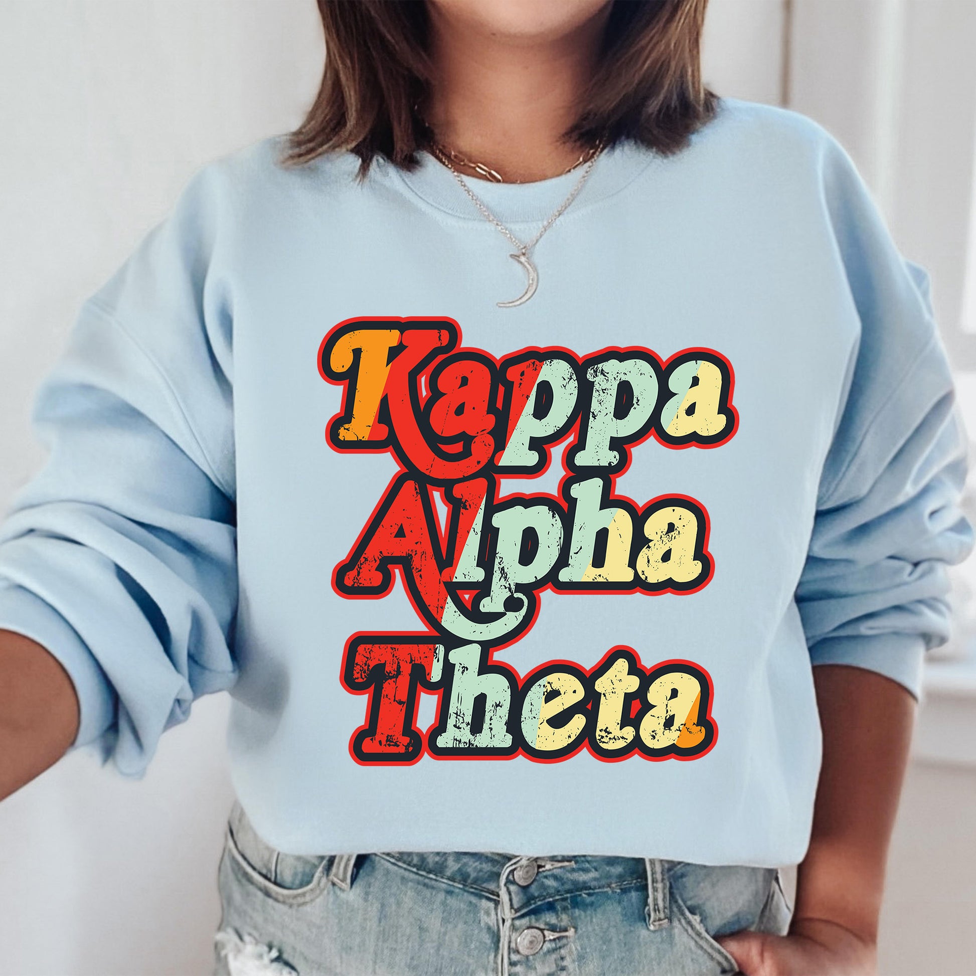 a woman wearing a light blue sweatshirt with the words kapaa aloha