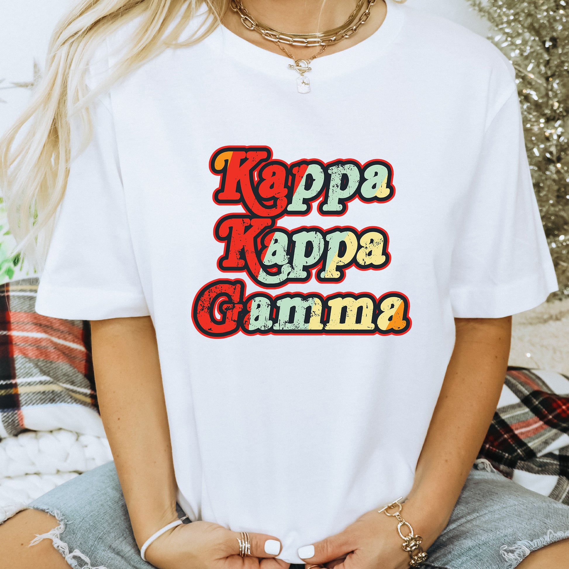 a woman wearing a white t - shirt that says tapa kappa gum