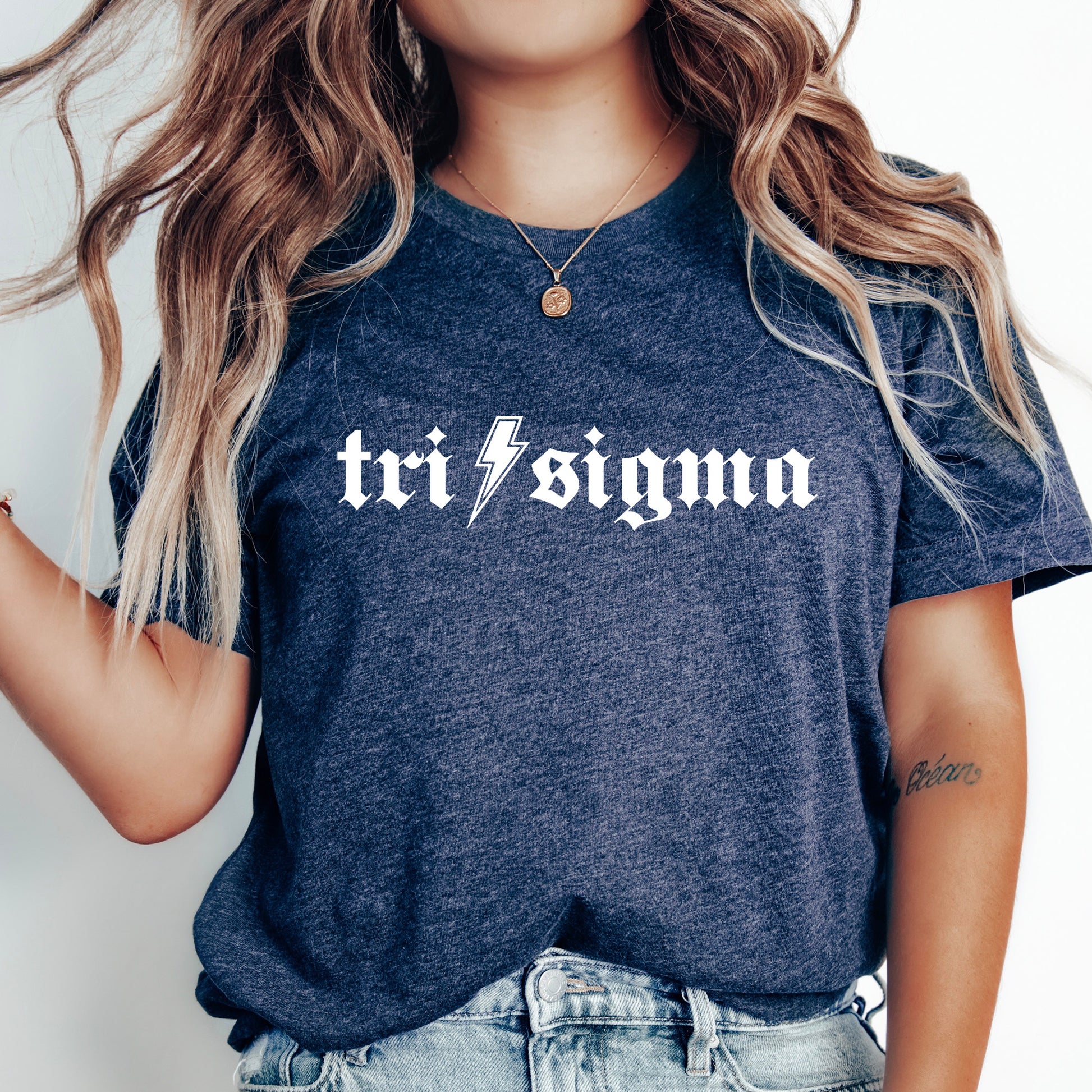 a woman wearing a t - shirt with the word tri stigma printed on it