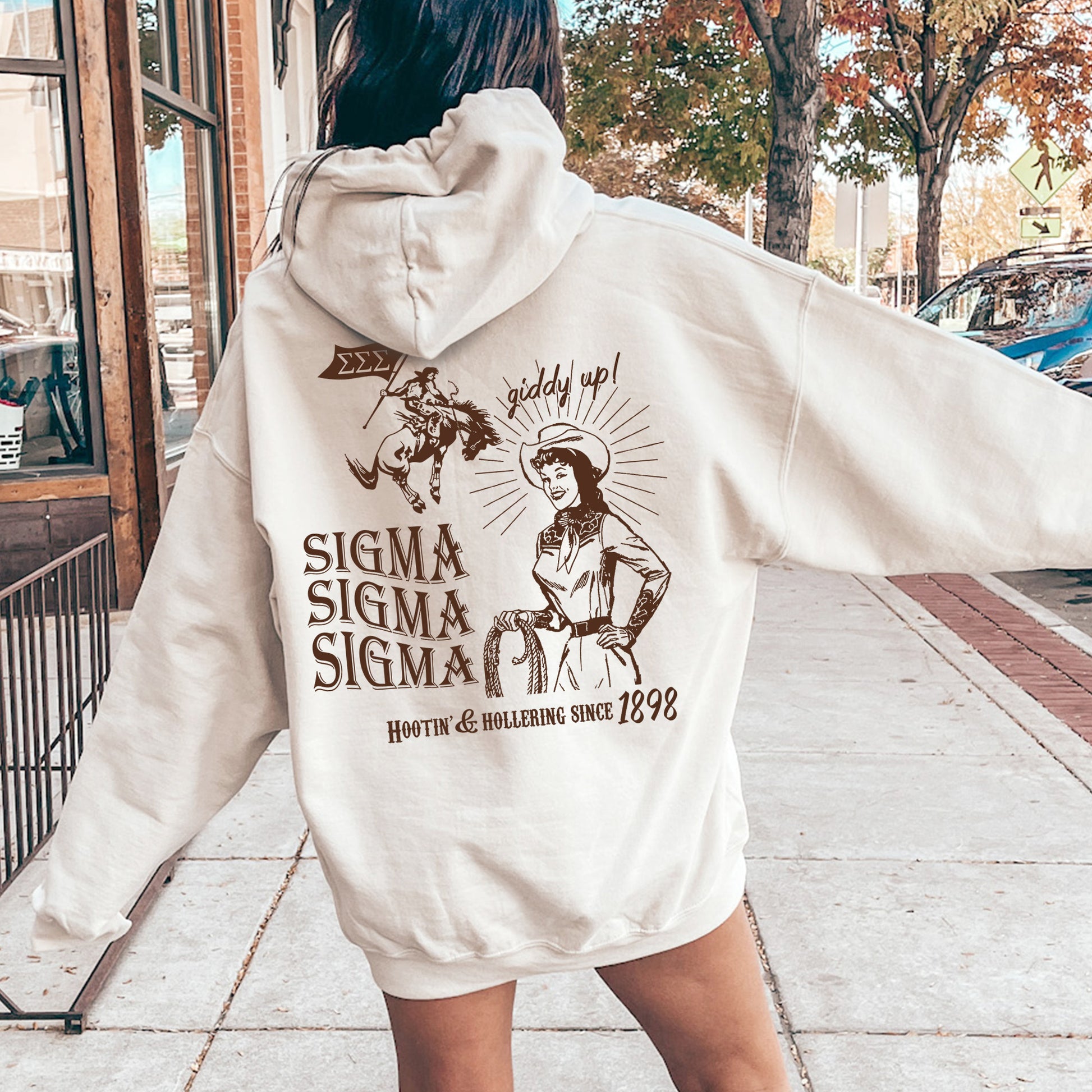 a woman in a white hoodie is walking down the street