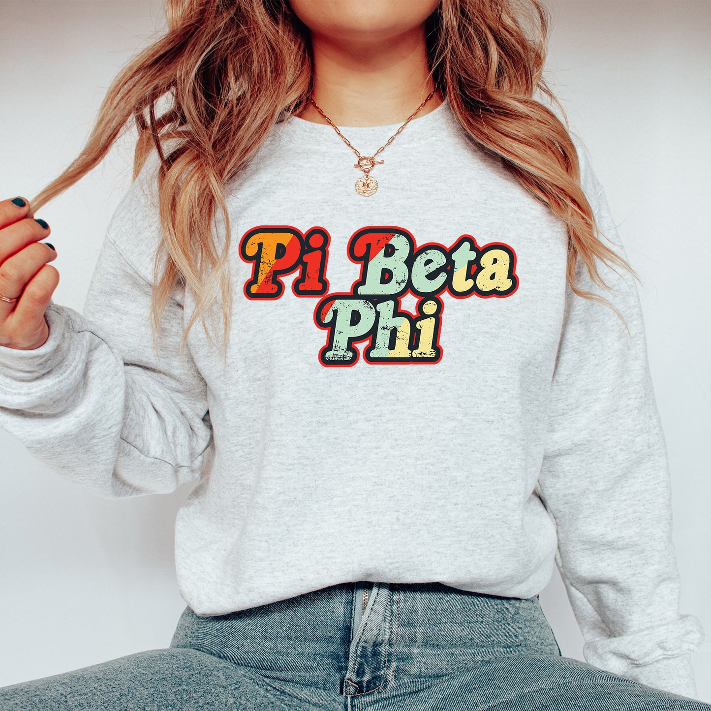 a woman wearing a sweatshirt that says pi beta phi
