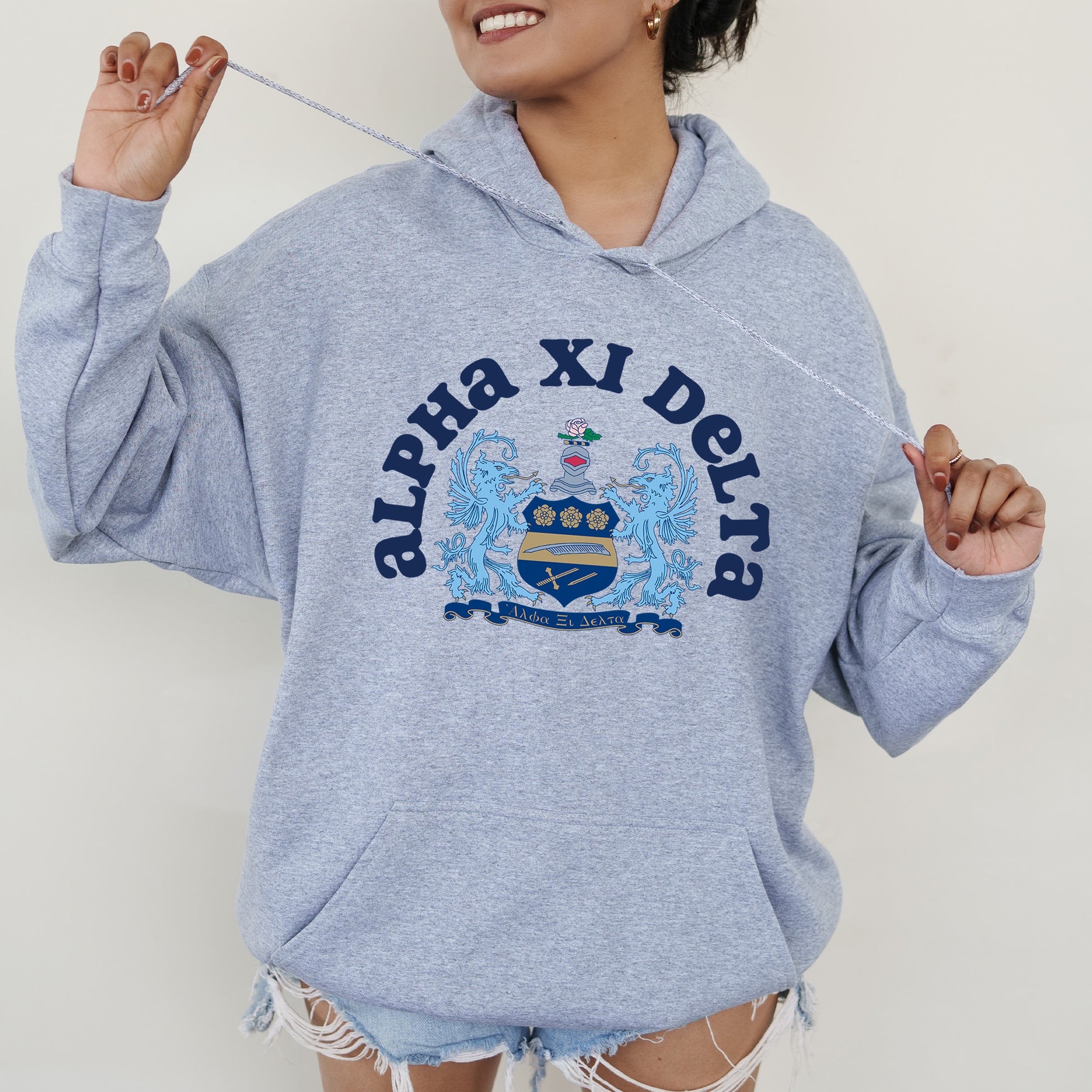 a woman in a blue hoodie holding a toothbrush