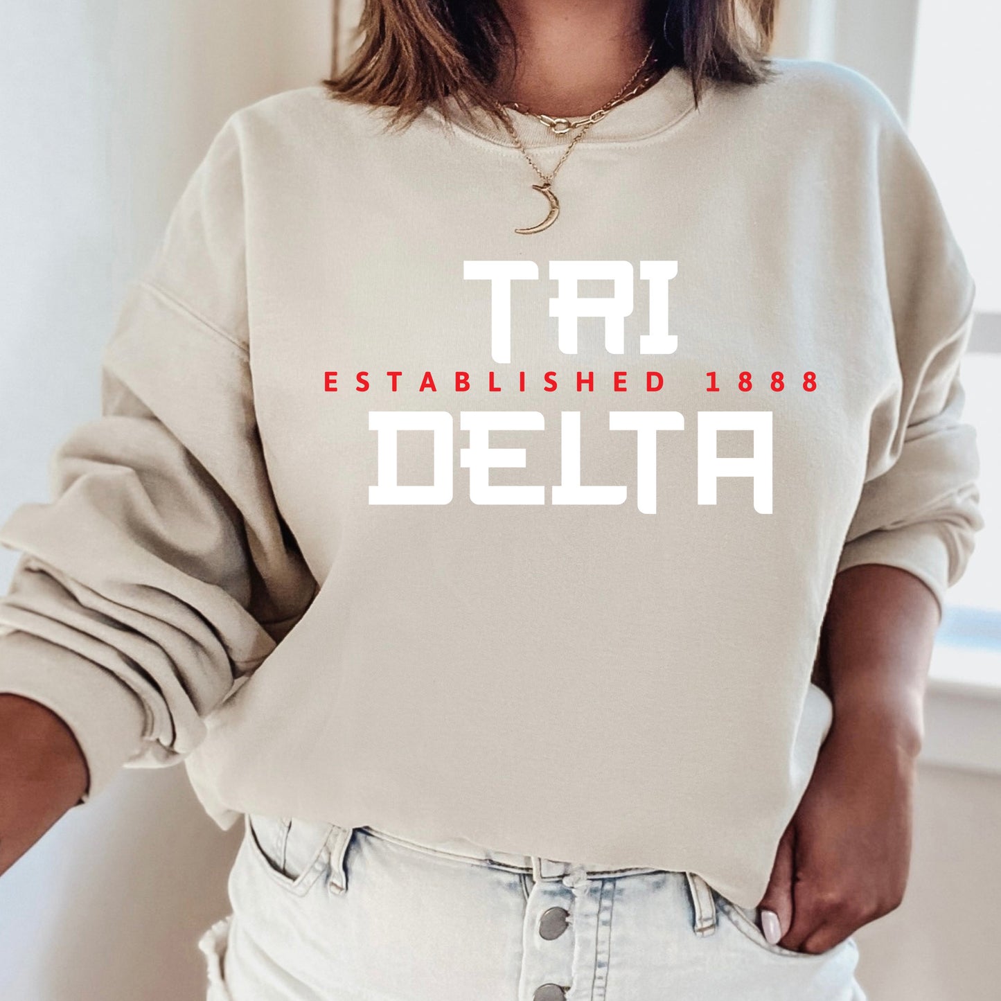a woman wearing a sweatshirt that says tru established in delta