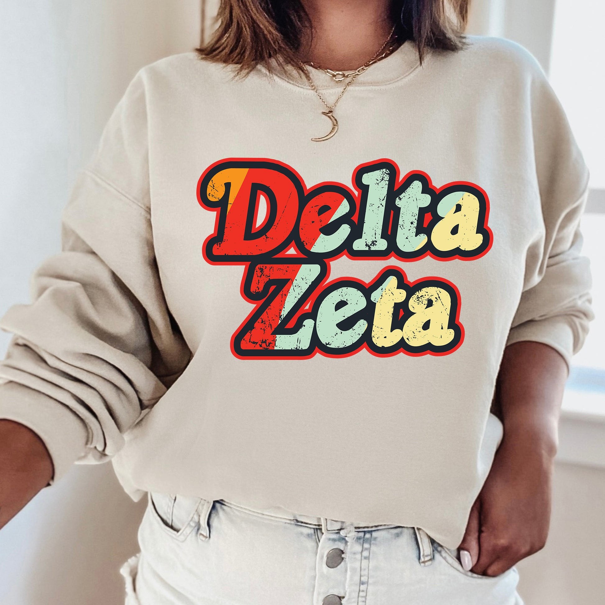 a woman wearing a sweatshirt that says delta zeta