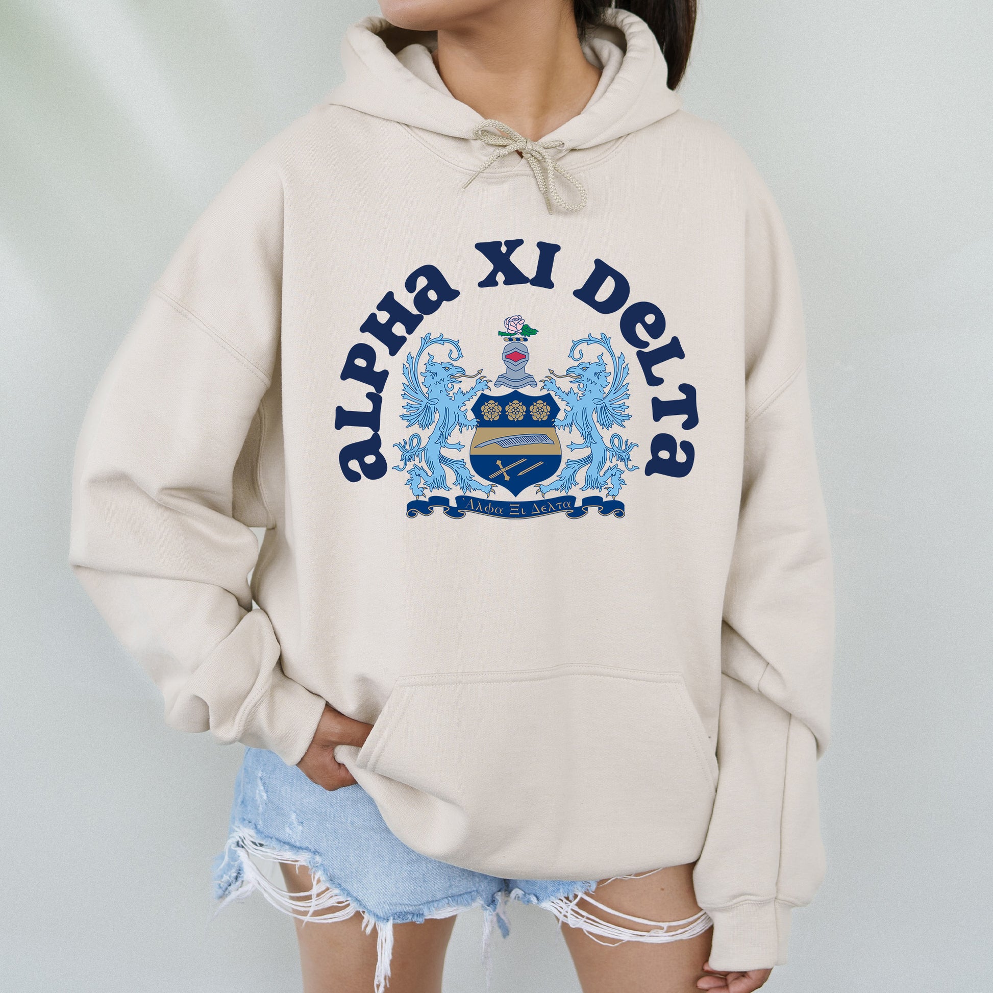 a woman wearing a white hoodie with a blue crown on it