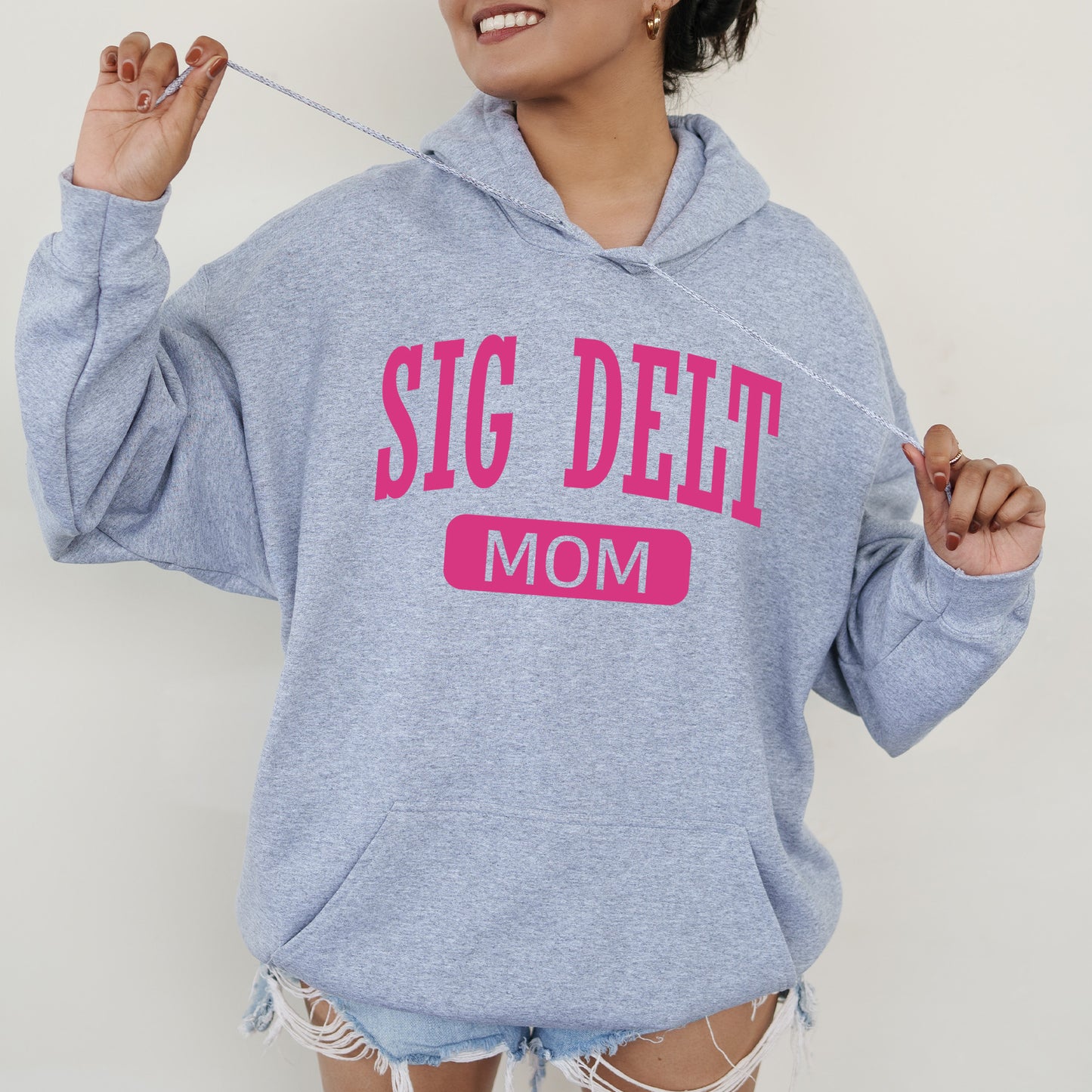 a woman wearing a blue sweatshirt with a pink slogan on it