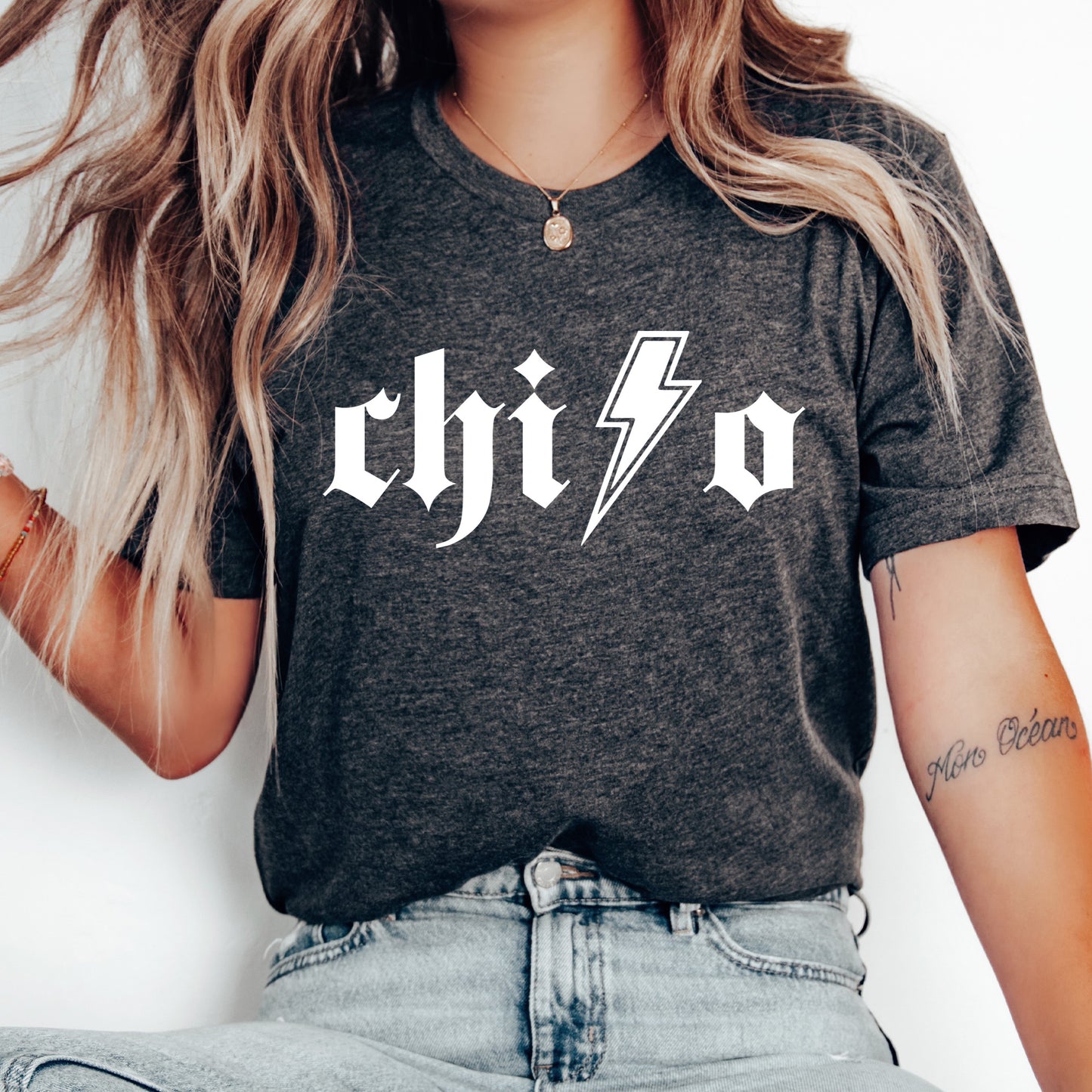 a woman wearing a black shirt with a lightning bolt on it