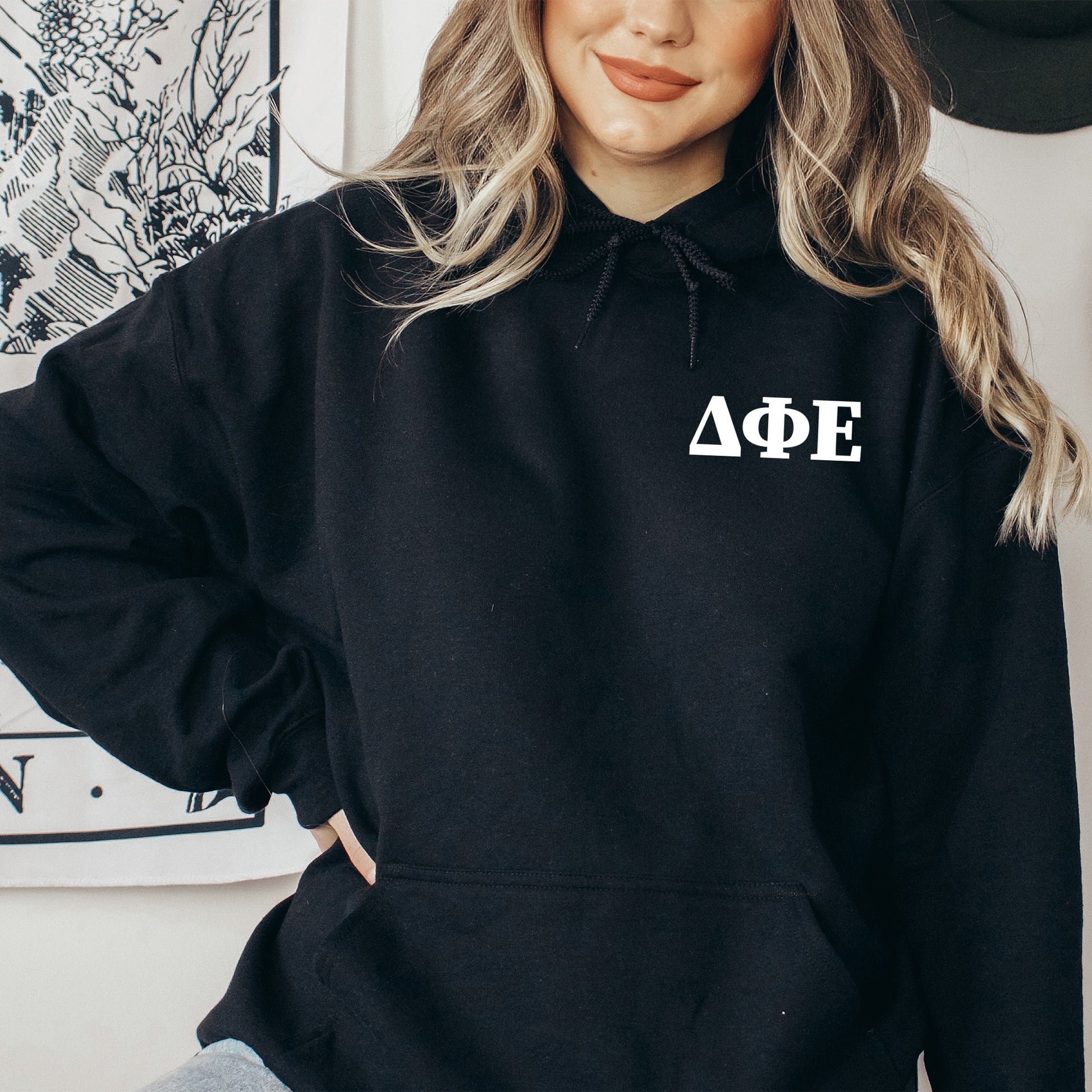 a woman wearing a black hoodie with the word aoe on it