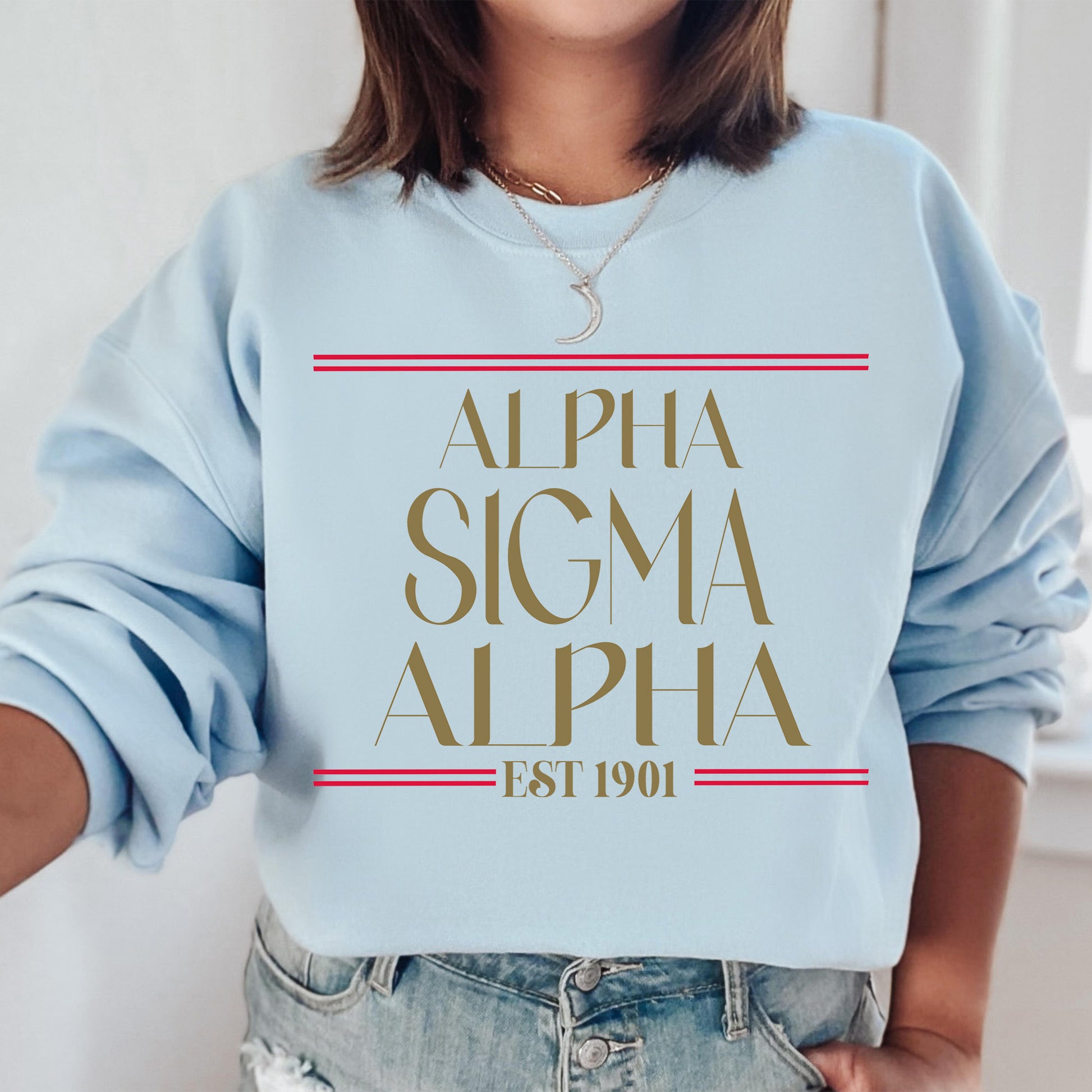 a woman wearing a blue sweatshirt with the words,'alpha sigma