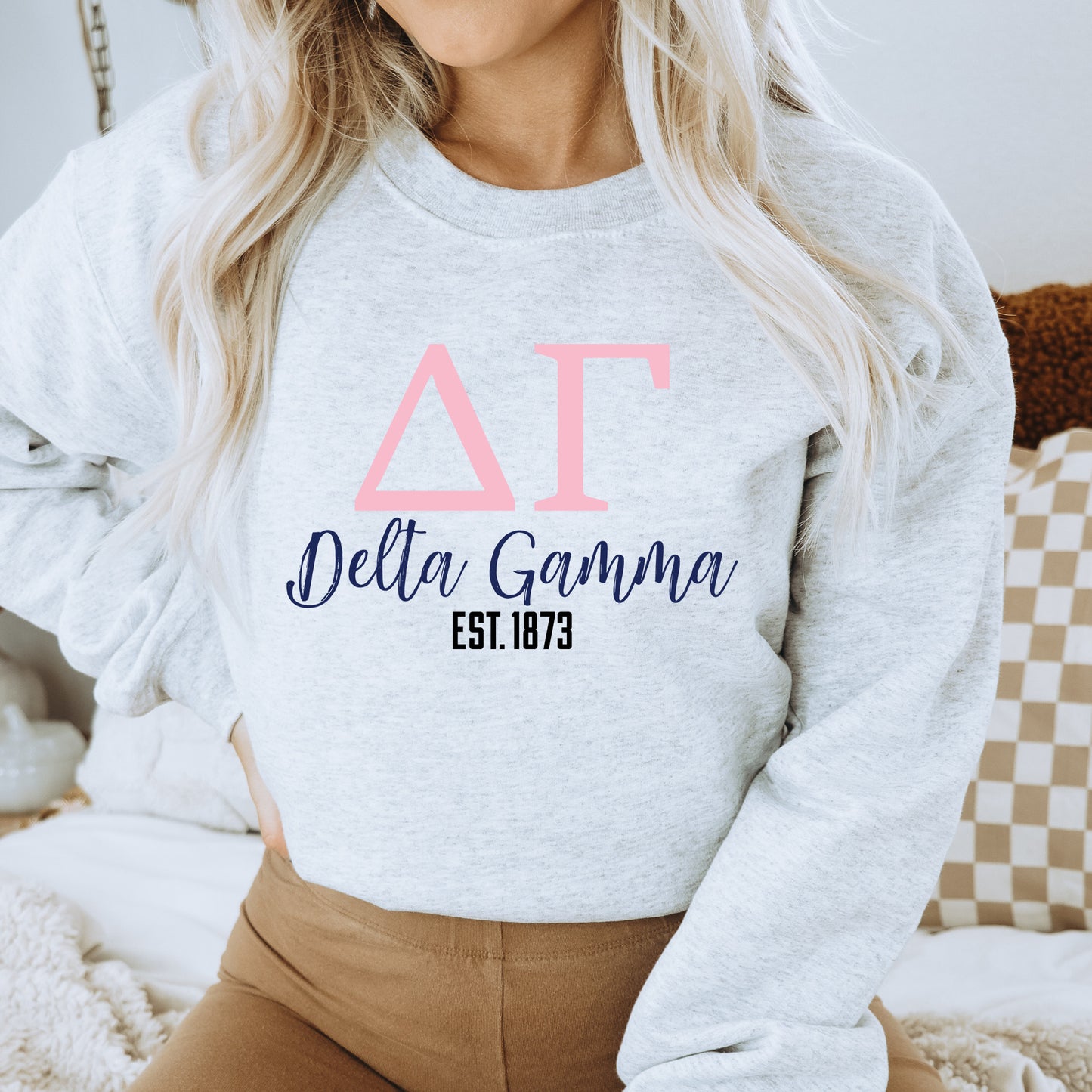 a woman wearing a sweatshirt that says delta garma est not