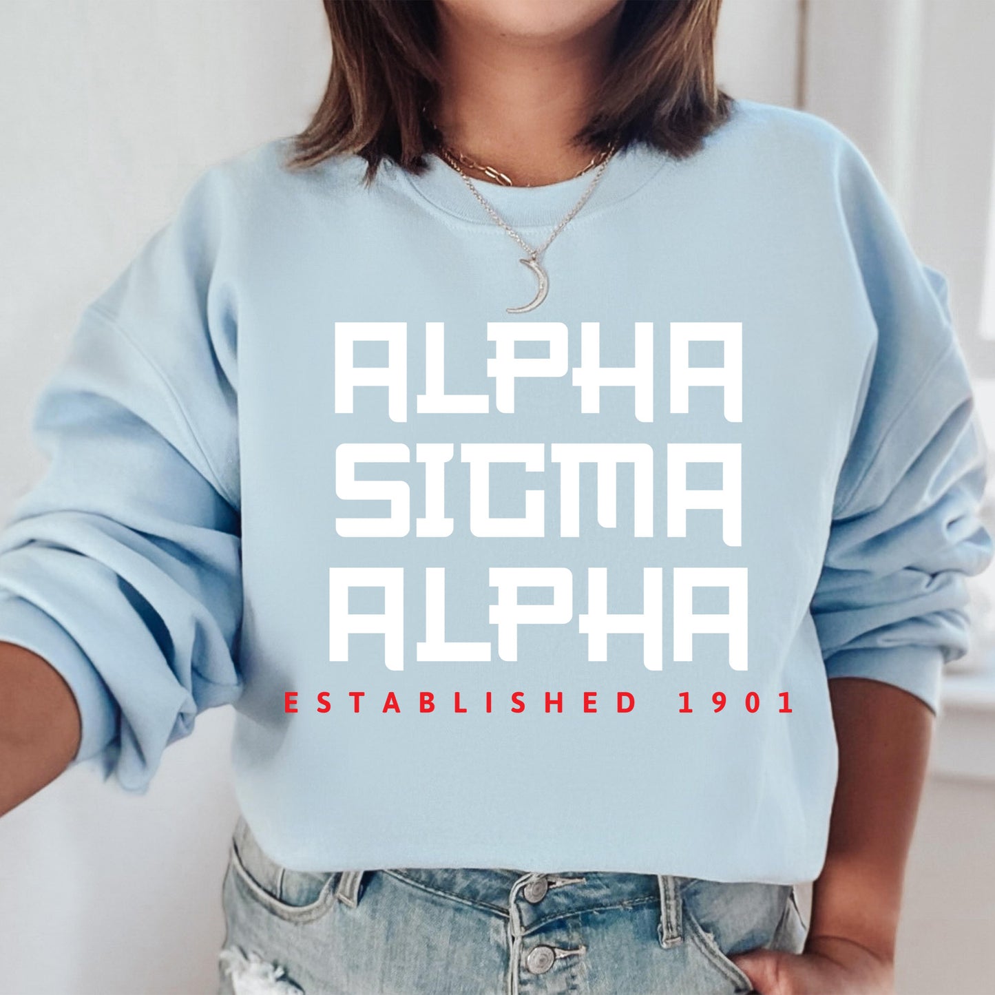 a woman wearing a blue sweatshirt with the words, alpha, alpha established