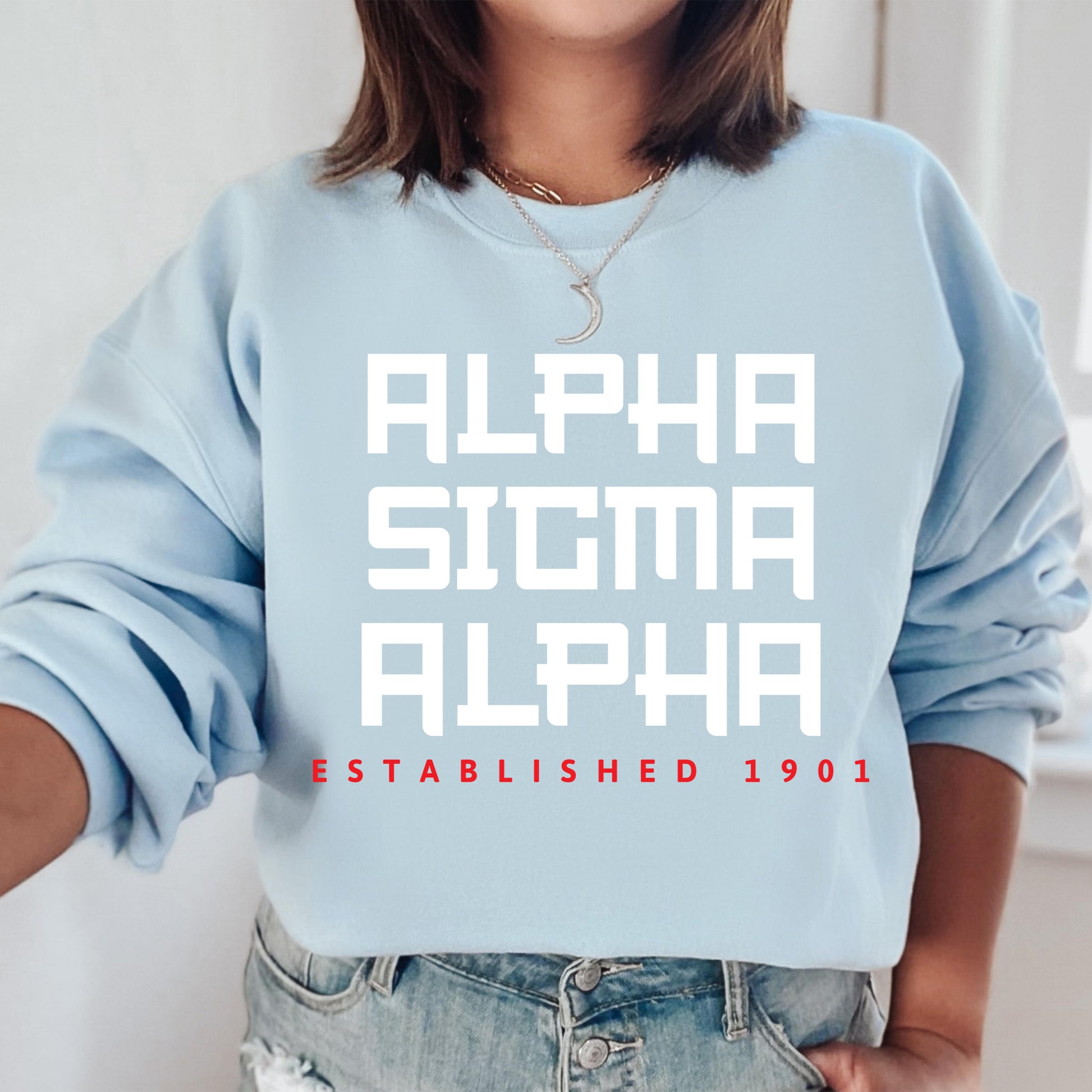 a woman wearing a blue sweatshirt with the words, alpha, alpha established