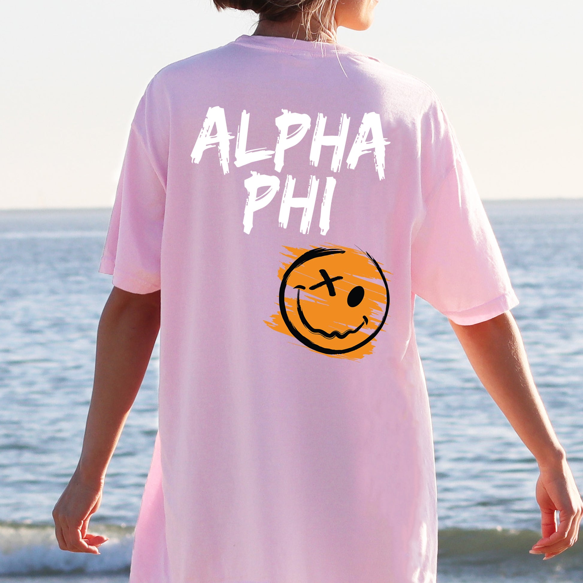 a person wearing a pink shirt with a smiley face on it