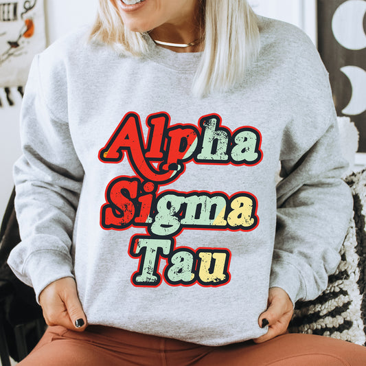 a woman sitting on a chair wearing a grey sweatshirt