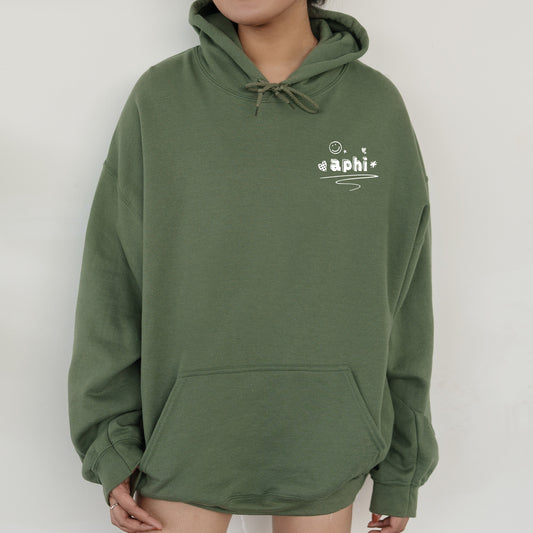 a person wearing a green hoodie with a smile on their face