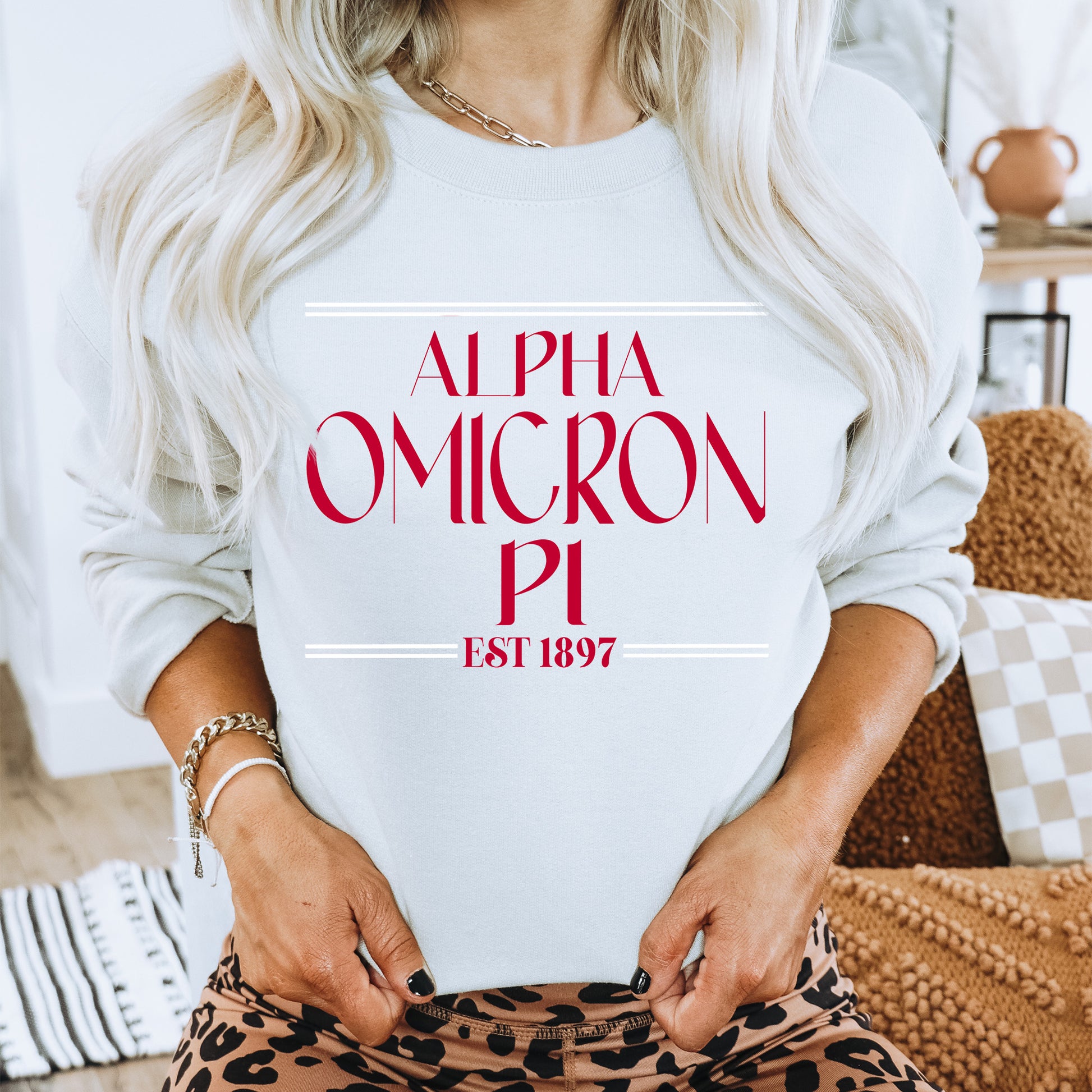 a woman wearing a white sweatshirt with a red graphic on it