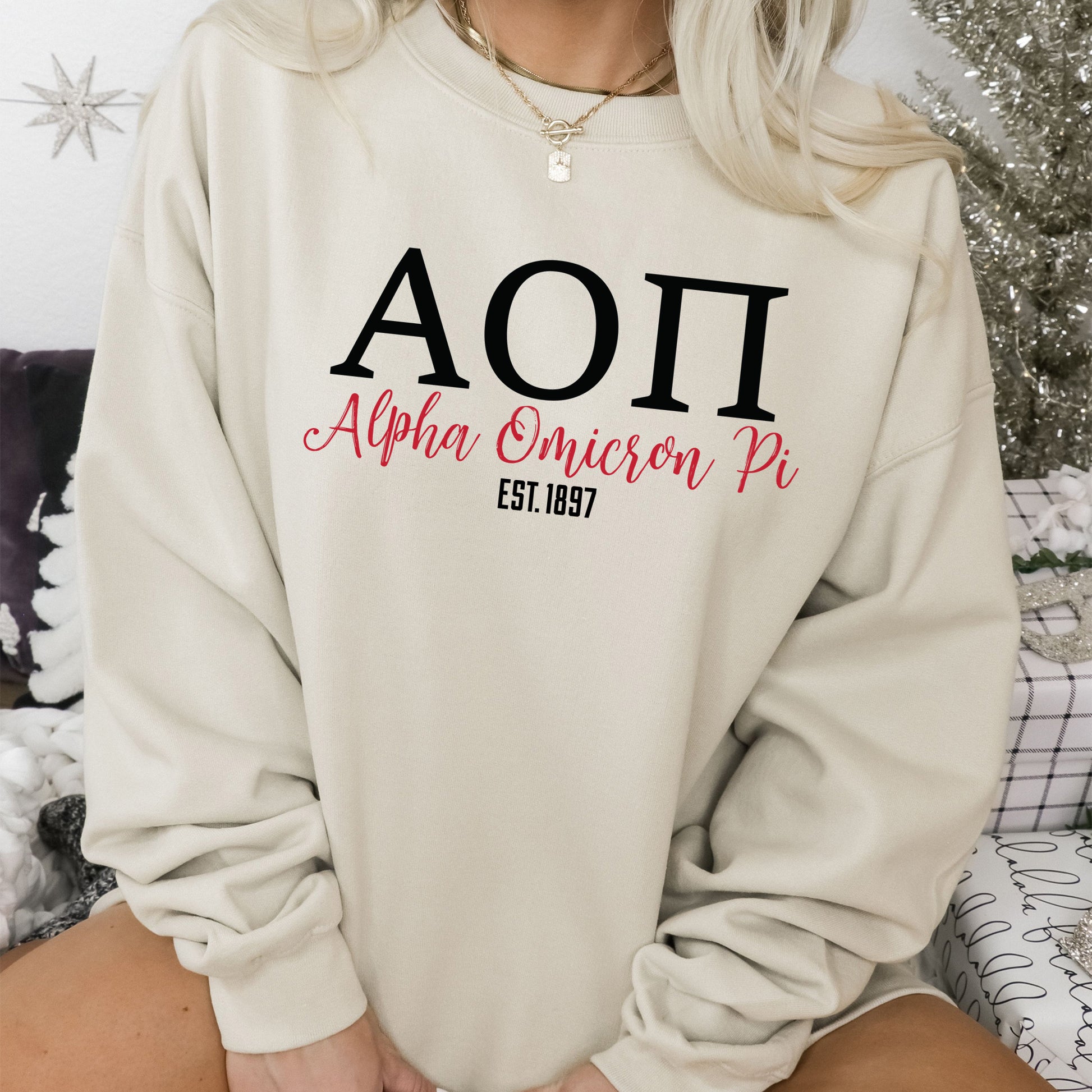 a woman sitting on a couch wearing a sweatshirt
