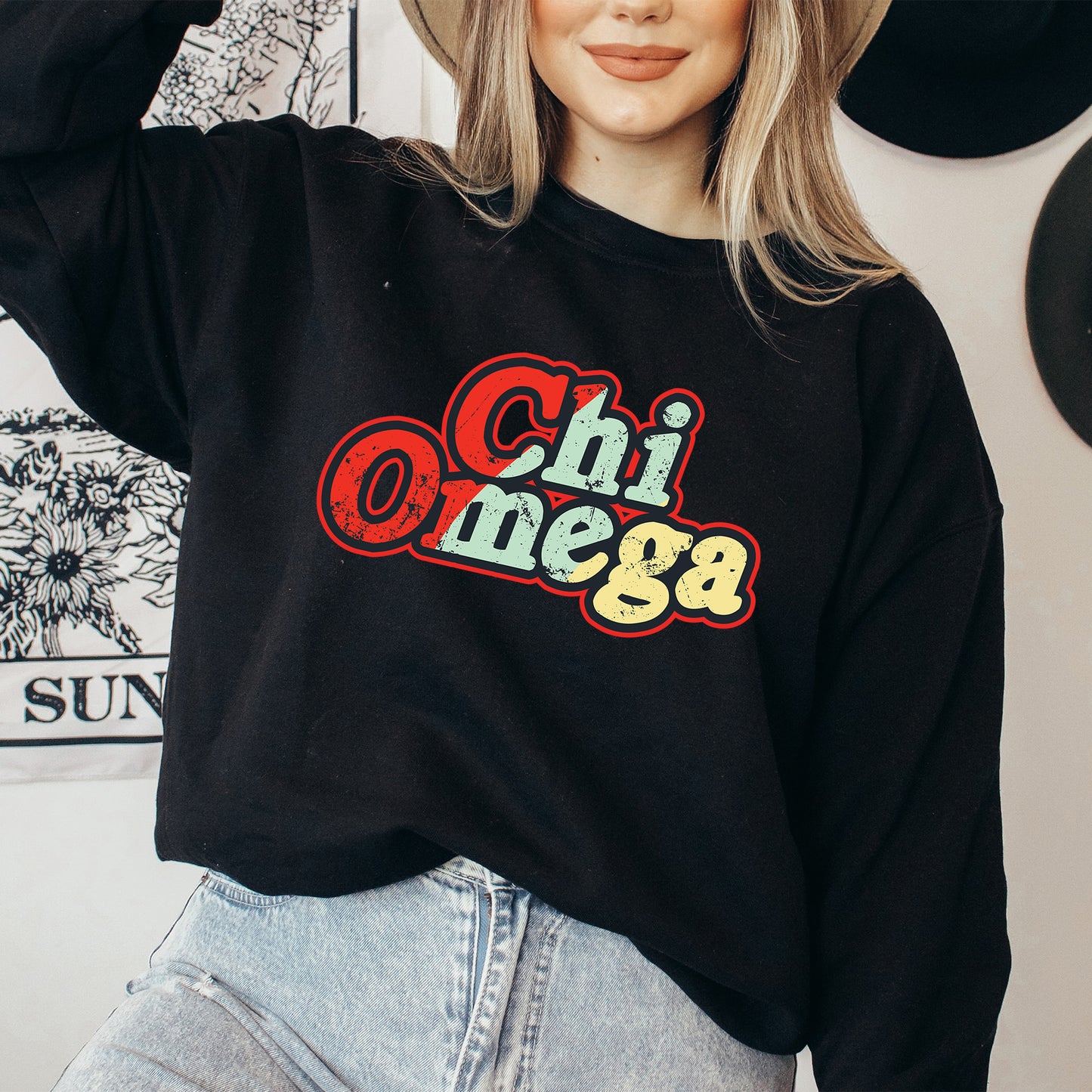 a woman wearing a hat and a black sweatshirt